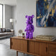 Phantom Purple Bear Sculpture - 50cm in glossy electroplated purple resin, displayed on a wooden sideboard in a living room near books and framed art.