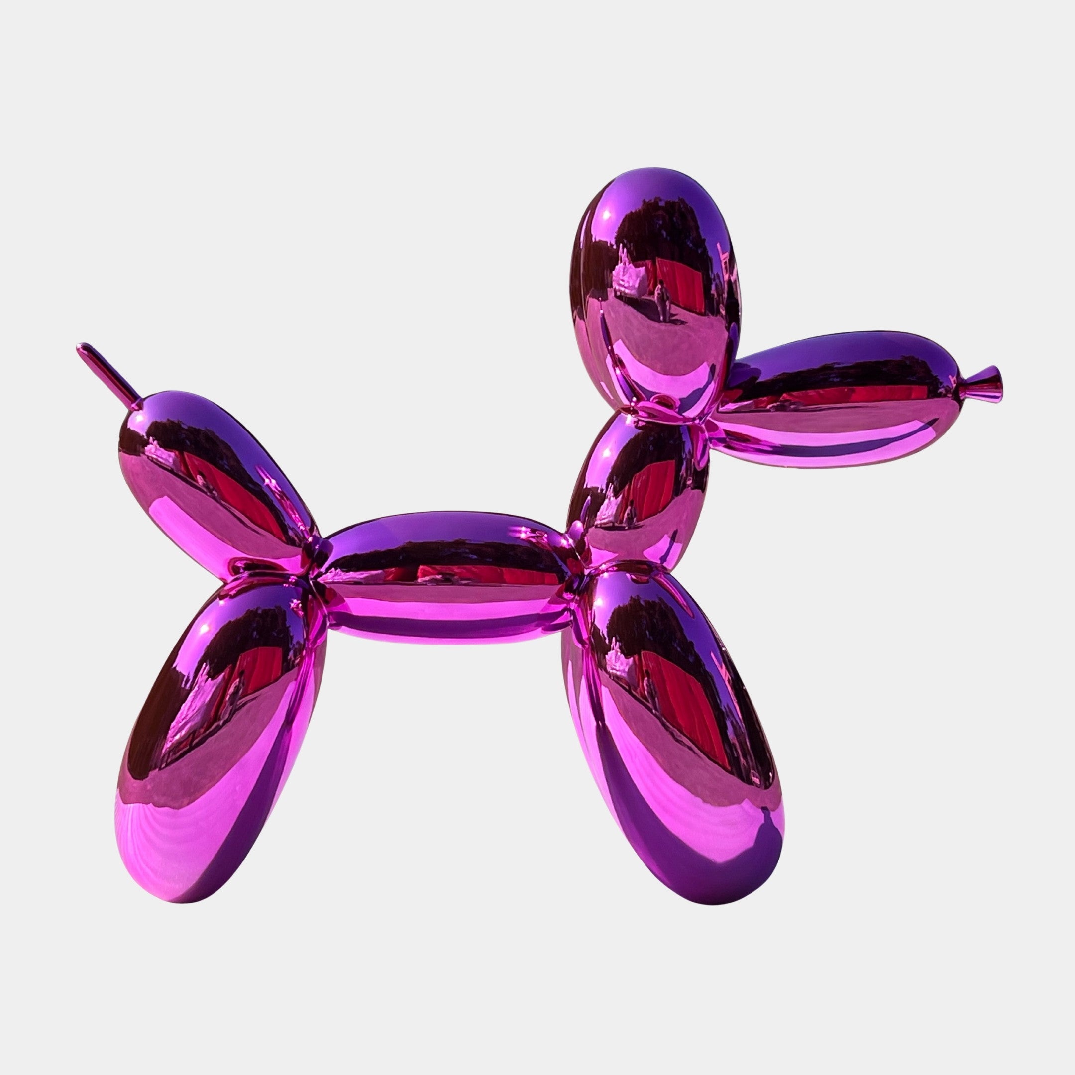 The Flamingo Pink Balloon Dog Sculpture - 80cm by Giant Sculptures is a shiny, metallic decor piece shaped like a balloon animal—perfect as a modern centerpiece.
