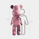 The Pinque Bear Sculpture - 165cm by Giant Sculptures, a large pink bear with a heart on its chest, stands in front of a gray 150 cm outline for scale, emphasizing its impressive 165 cm (5 ft 5 in) height.