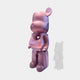 The Giant Sculptures Pinque Bear Sculpture - 50cm features pink and purple hues, stands upright with a white heart on its chest, and casts a subtle translucent shadow on a light gray background—a charming contemporary art piece.