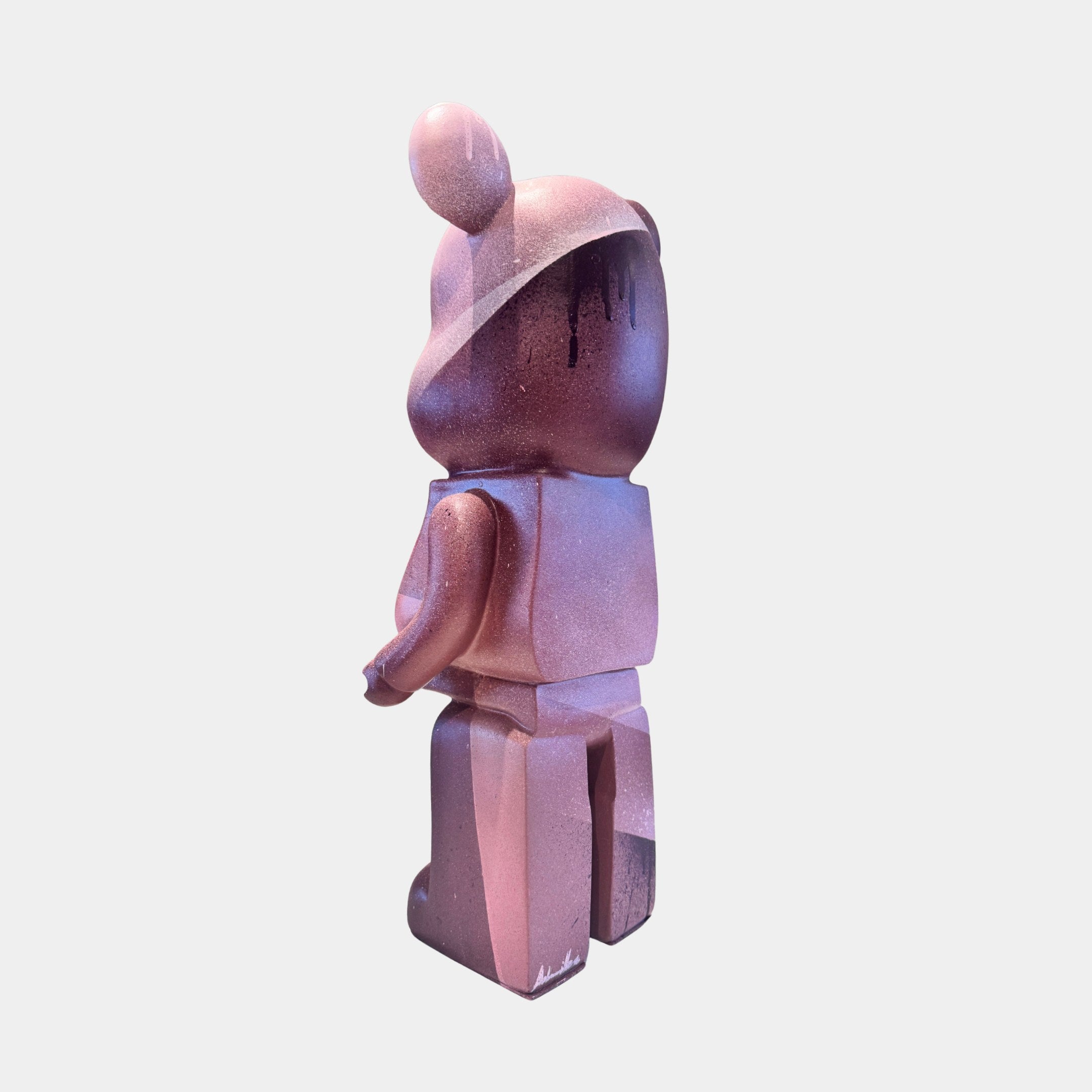 The Pinque Bear Sculpture - 50cm by Giant Sculptures features pink and purple paint drip effects, standing upright against a white background—a bold, contemporary art toy figure.