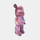 The Pinque Bear Sculpture - 50cm by Giant Sculptures features a pink and purple design, rounded shape, shiny speckled finish, and a small white heart on its chest—an eye-catching limited edition art piece.