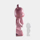 The Giant Sculptures Pinque Bear Sculpture - 50cm, in shiny pink, stands upright in profile on a white background. A small, semi-transparent version of this limited edition piece appears near its feet, overlapping the shadow.