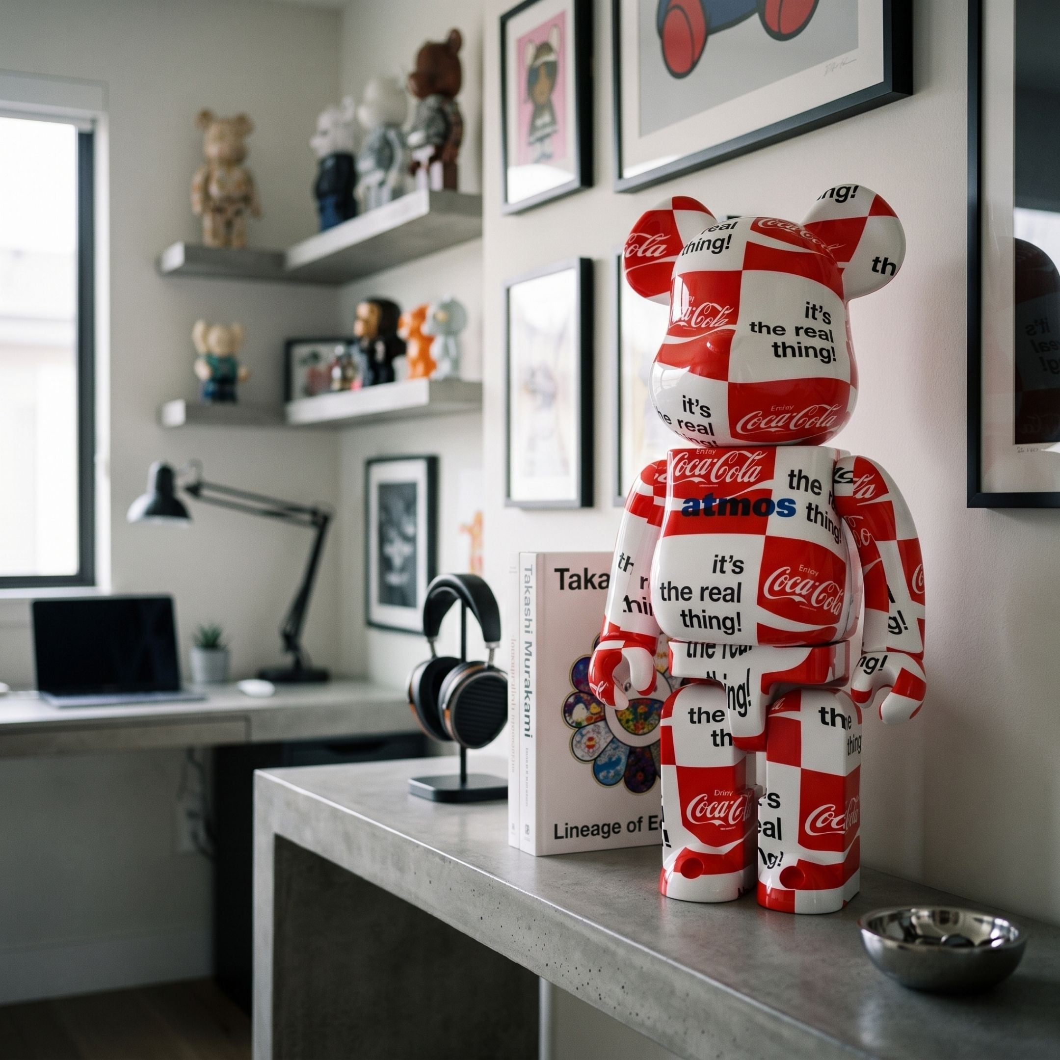 Pop Checkerboard Bear Sculpture - 70cm in red, white, and black with Coca-Cola graphics, displayed on a desk shelf in a home office setting.