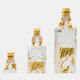 Clear Gilded Tree Column Cast Resin Sculpture in three heights (135/158/200cm), each topped with a gold-headed guardian lion and gold tree relief, on a plain white background.