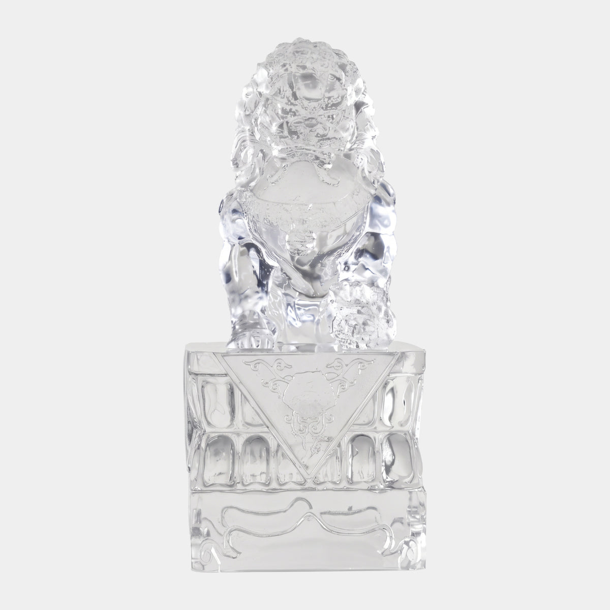 Clear Guardian Lion on Carved Resin Plinth (44cm) by Giant Sculptures, paw on ball, carved mane and scrollwork base, against a plain white background.