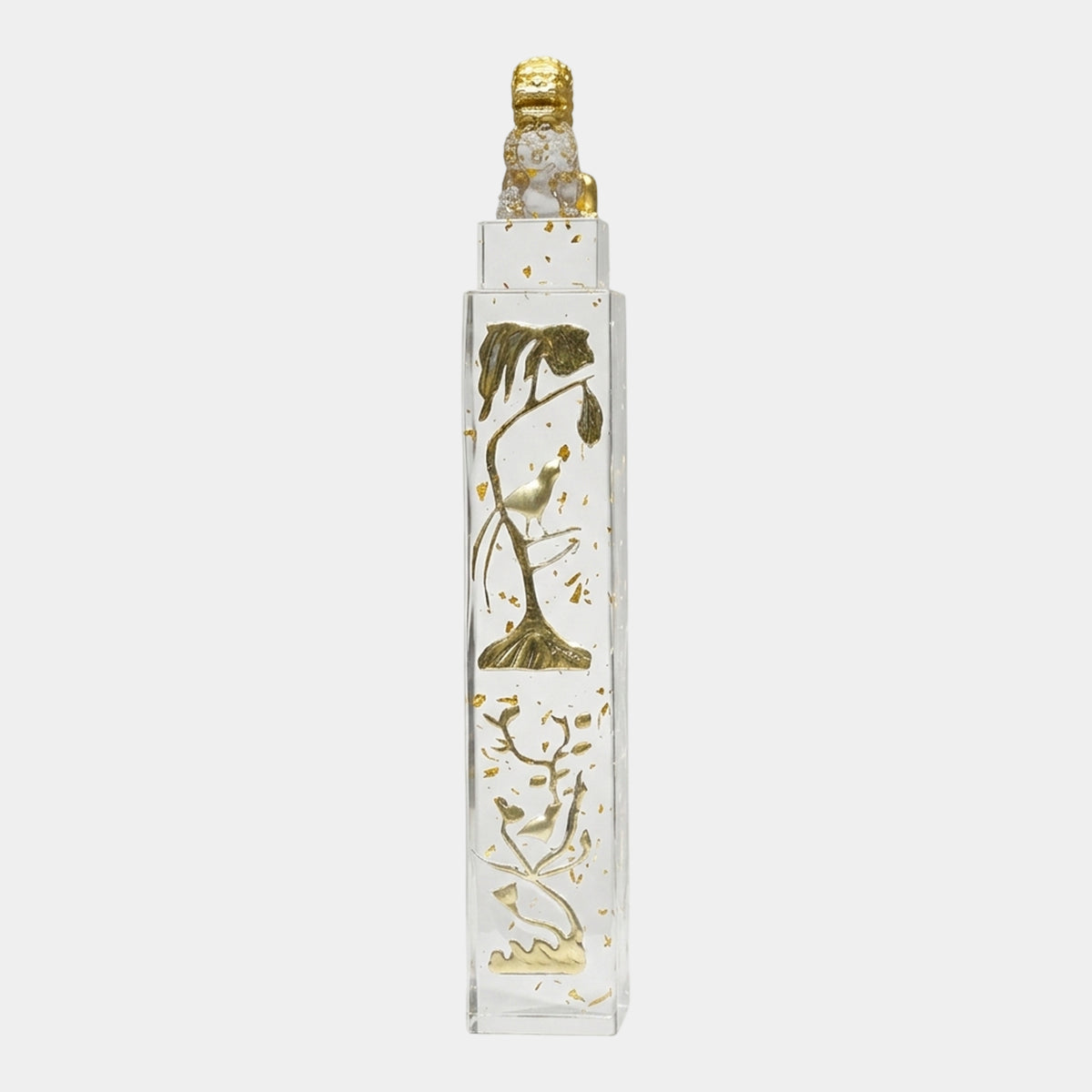 Clear Gilded Lion Column Cast Resin Sculpture - 69cm, a clear resin column with gold leaf flecks, gilded bird and branch reliefs, and a small gold lion atop the flat cap, shown on a plain white background.