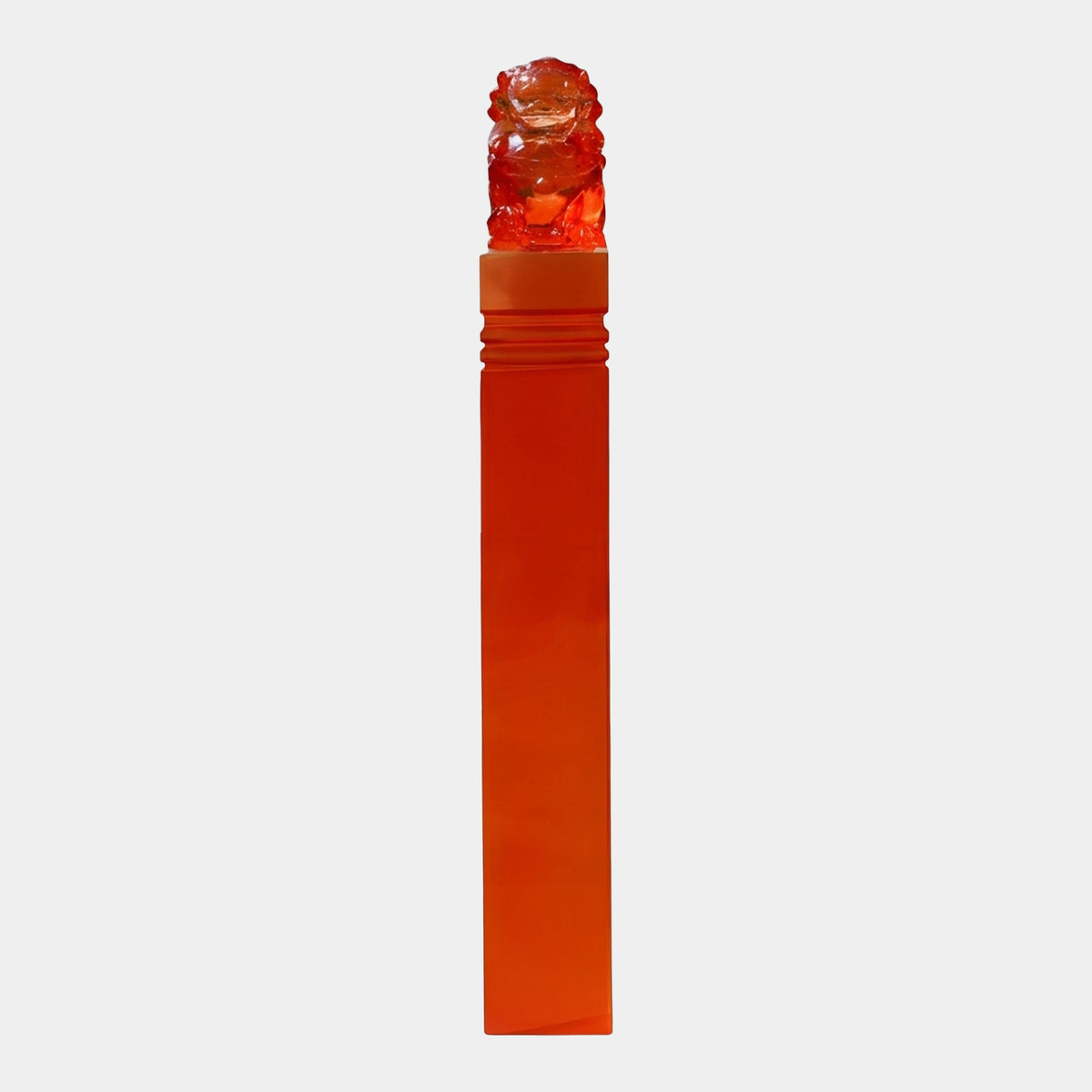 Red Banded Lion Column Cast Resin Sculpture, 133cm, translucent orange-red resin column with carved lion atop, on plain light background.