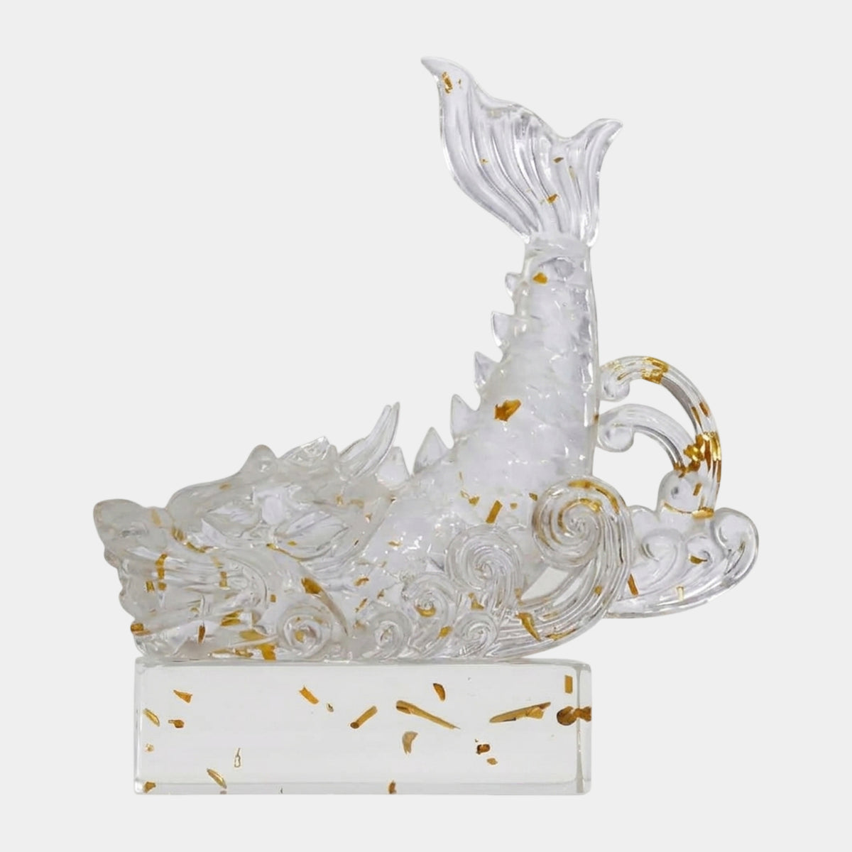 Clear Gold-Leaf Fish-Tailed Dragon (22cm) resin sculpture with gold leaf flecks, curved tail rising above waves, on a clear base against a white background.