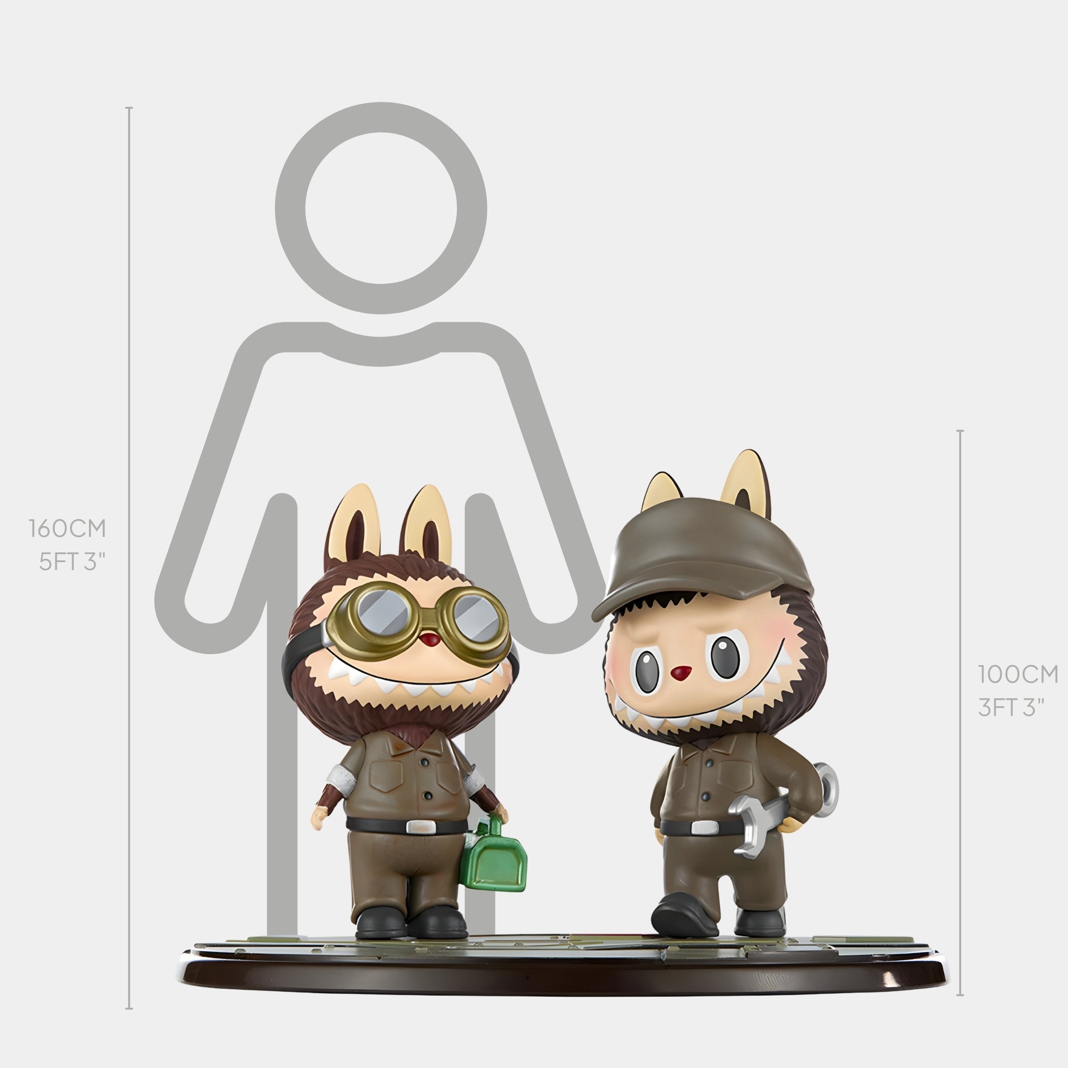 The Workshop Crew Labubu Mecha Sculpture (100cm) by Giant Sculptures features two pilot-themed animal figurines—one with a green bag, the other with a wrench—ideal for fans of fibreglass Labubus and industrial stories. Height comparison shown in back.