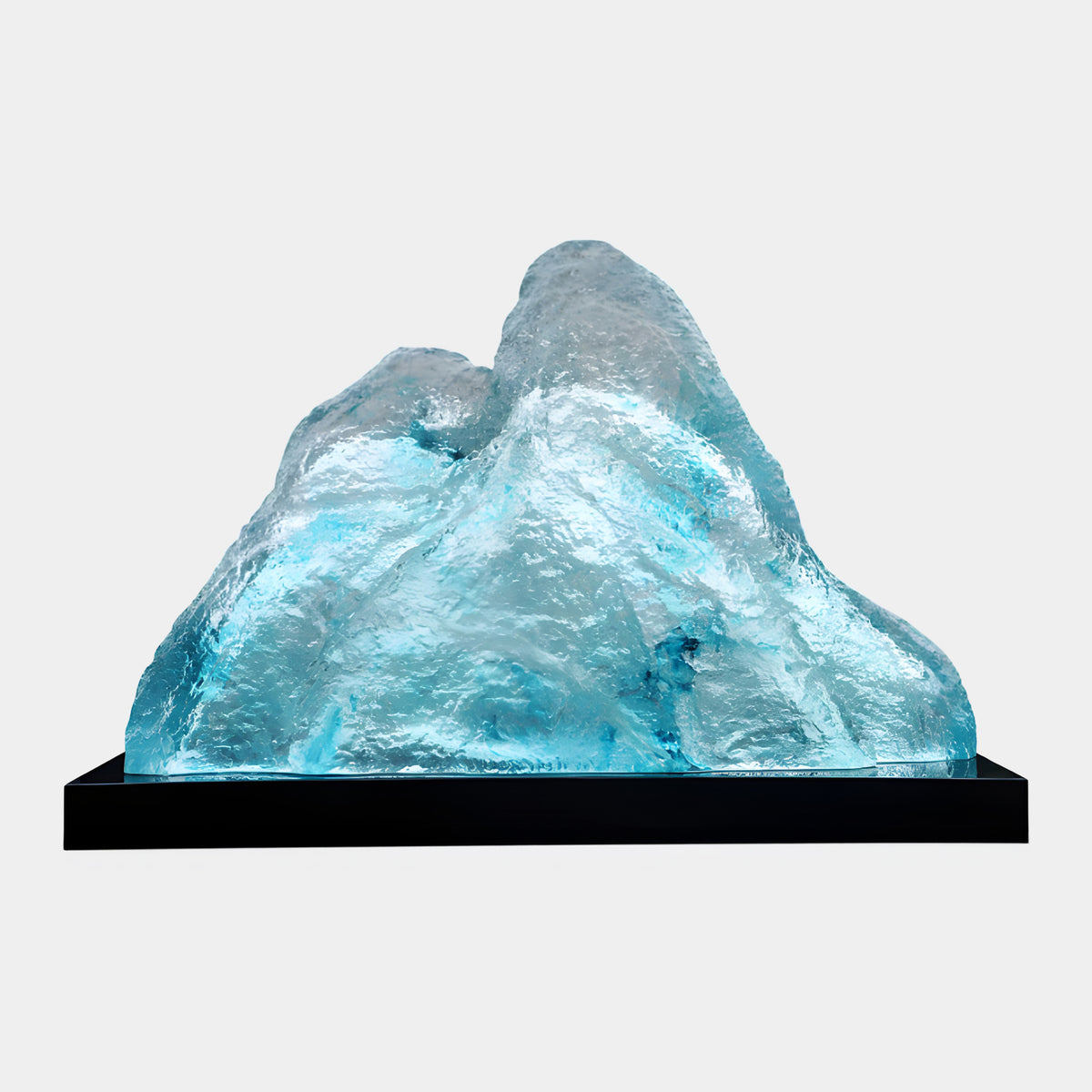 Aqua Ice Textured Mountain on Black Marble Resin Sculpture, 120cm, with twin peaks and icy turquoise ridges on a long black marble base, plain light background.