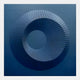 The Solveta Steel Blue Spiral Wood Relief 3D Wall Art by Giant Sculptures features a dark blue circular geometric design with radiating lines and a shaded, dimensional effect—striking modern wall decor for any space.