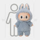 The Fluffy Walkers Frost Blue Labubu Sculpture by Giant Sculptures stands 160 cm tall, shown in a blue bunny costume with a big smile and large eyes, posed before a gray human outline for scale.