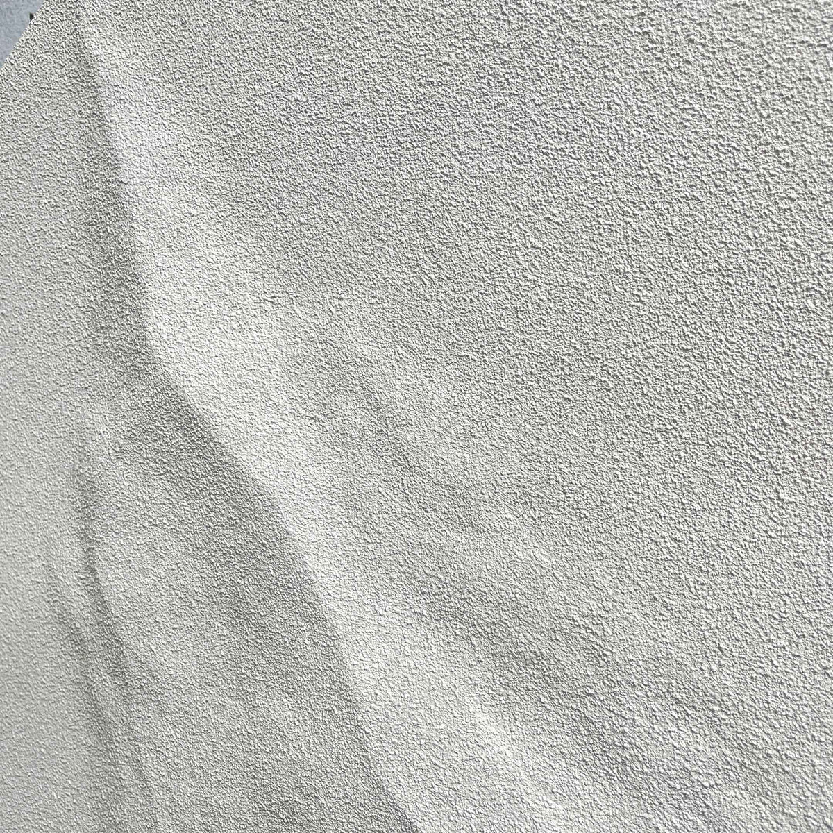 Selene V White Sandstone Textured 3D Wood Relief Wall Art close-up, showing diagonal creased ridges and a rough, pale white stone-like textured finish.