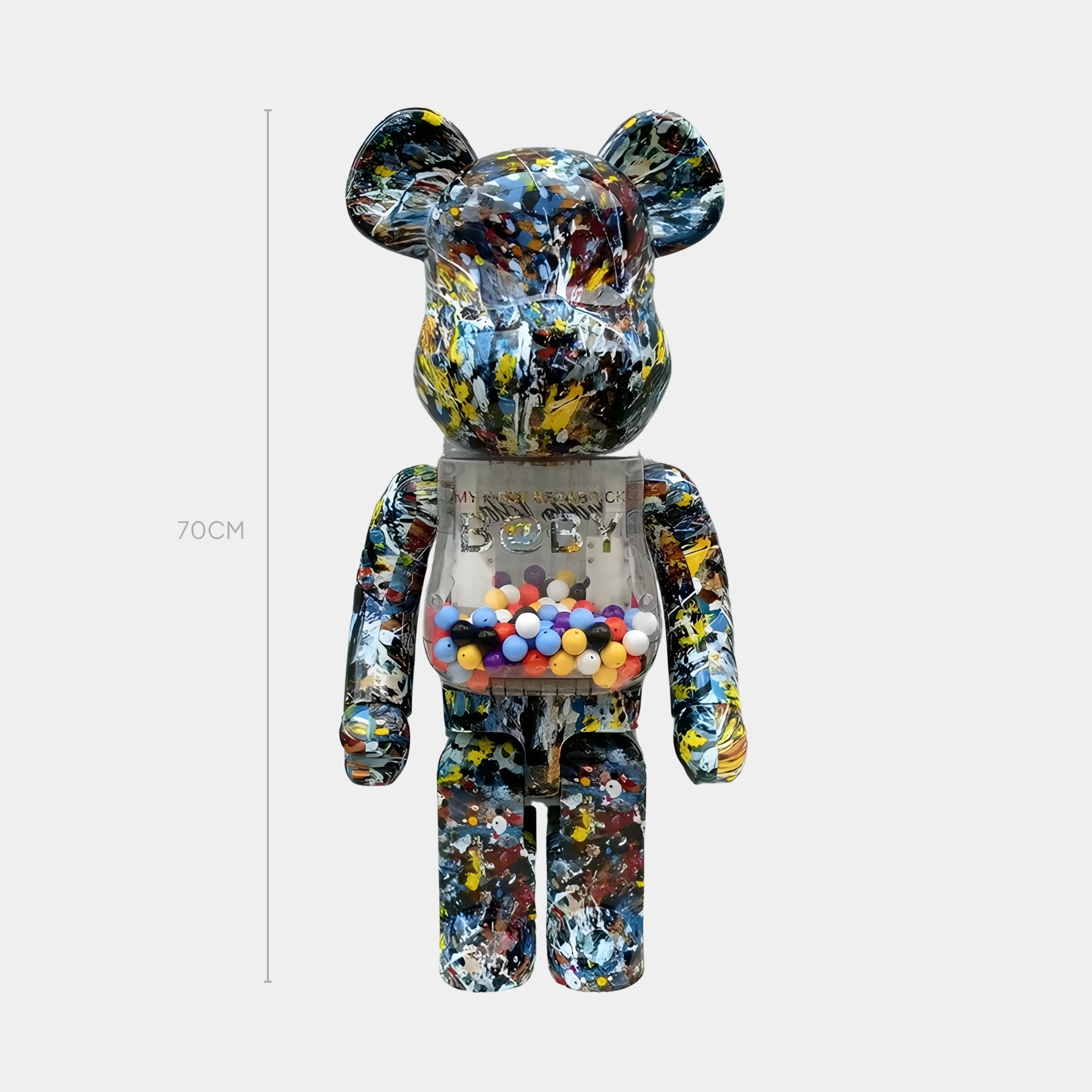 The Giant Sculptures Splatter Prism Bear Sculpture - 70cm features a multicolored paint-splatter design and a transparent chest filled with vibrant gumball-like spheres, creating a striking display against a plain background.