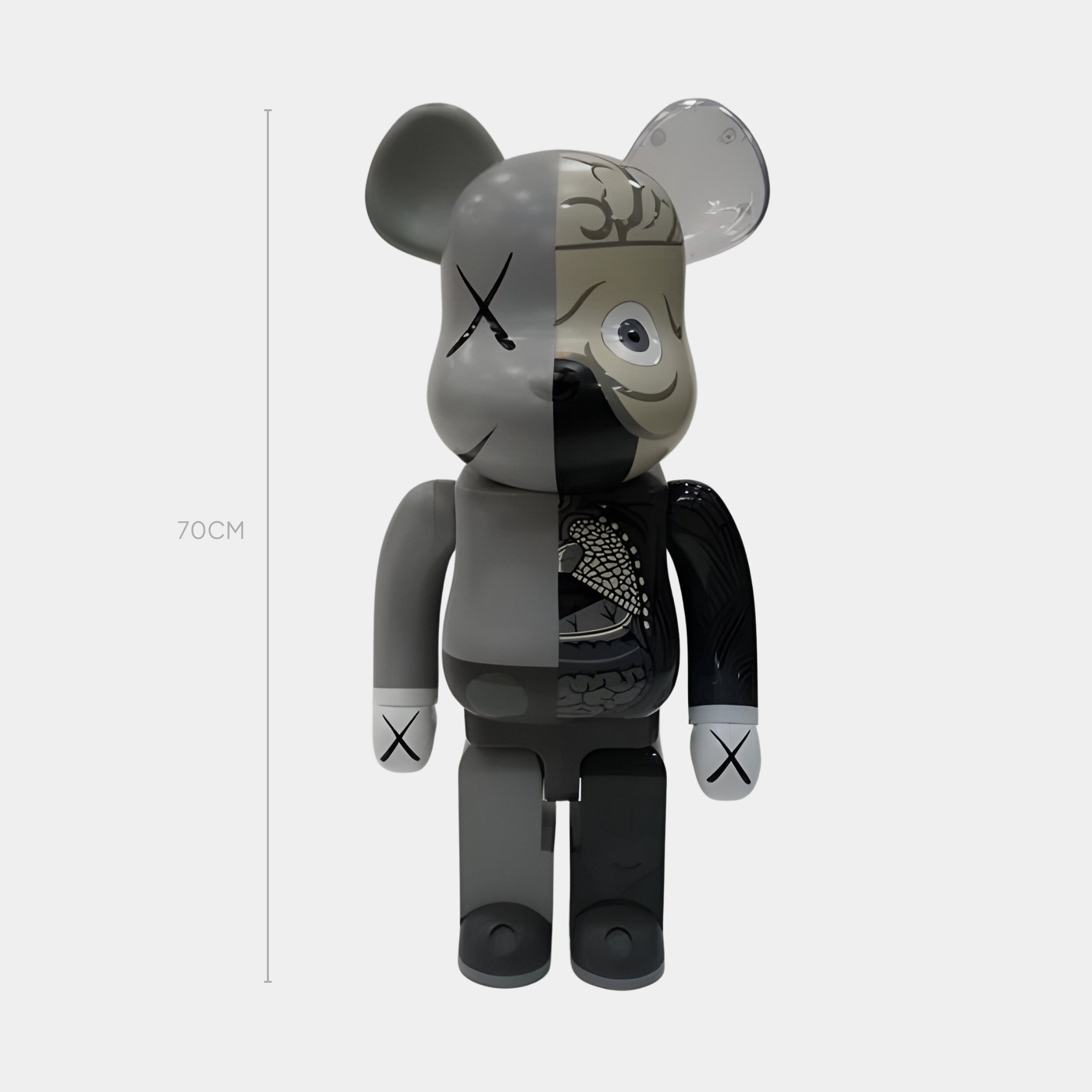 The Giant Sculptures Split Anatomy Grey Bear Sculpture - 70cm stands upright, featuring a monochrome design: the left side is solid grey with Xs for eyes and hands, while the right side shows detailed black and grey anatomy.