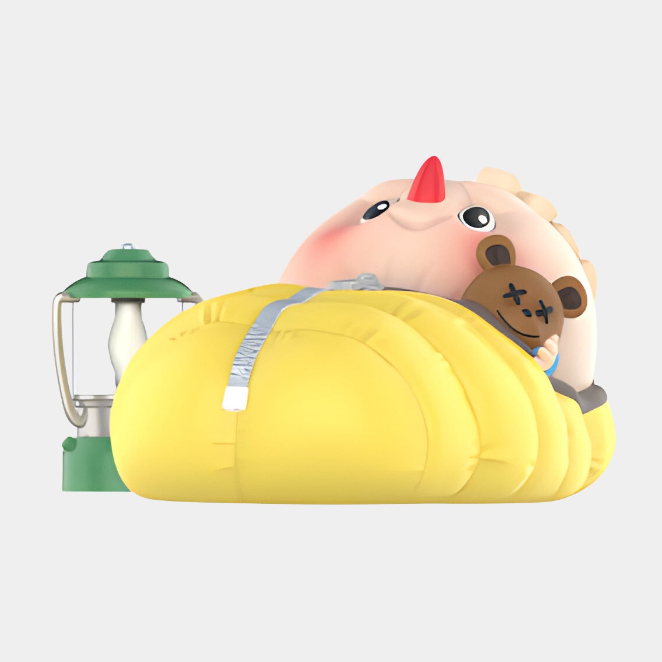 The Giant Sculptures Camp Life Spooky Sleeper Labubu Sculpture (100cm) features a cute cartoon dinosaur with a red horn in a yellow sleeping bag, hugging a teddy bear beside a green camping lantern—ideal for whimsical indoor displays.