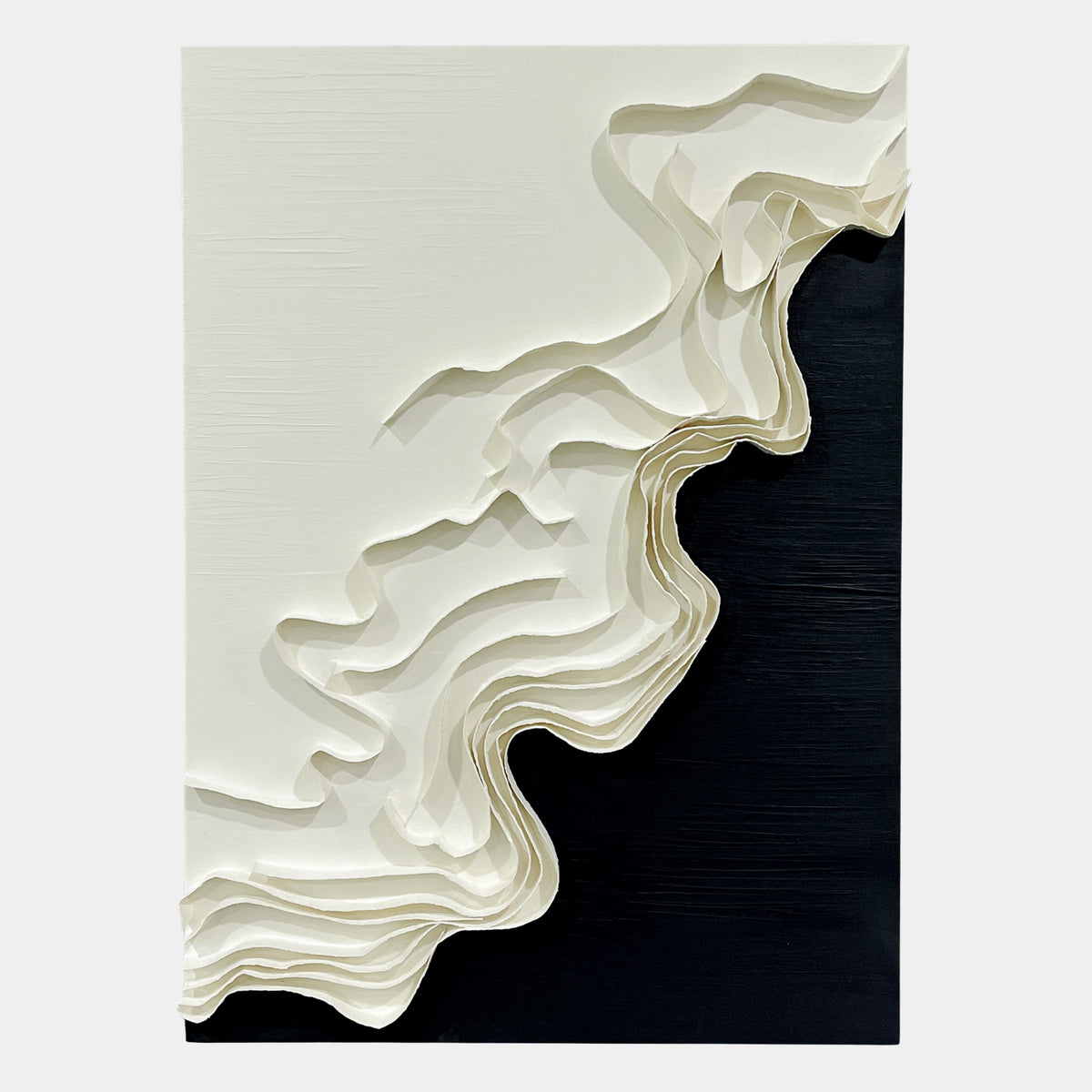 Stratura I Black & White Layered Paper Canvas Wall Art showing stacked white paper ridges forming a diagonal wave across a black and white canvas.