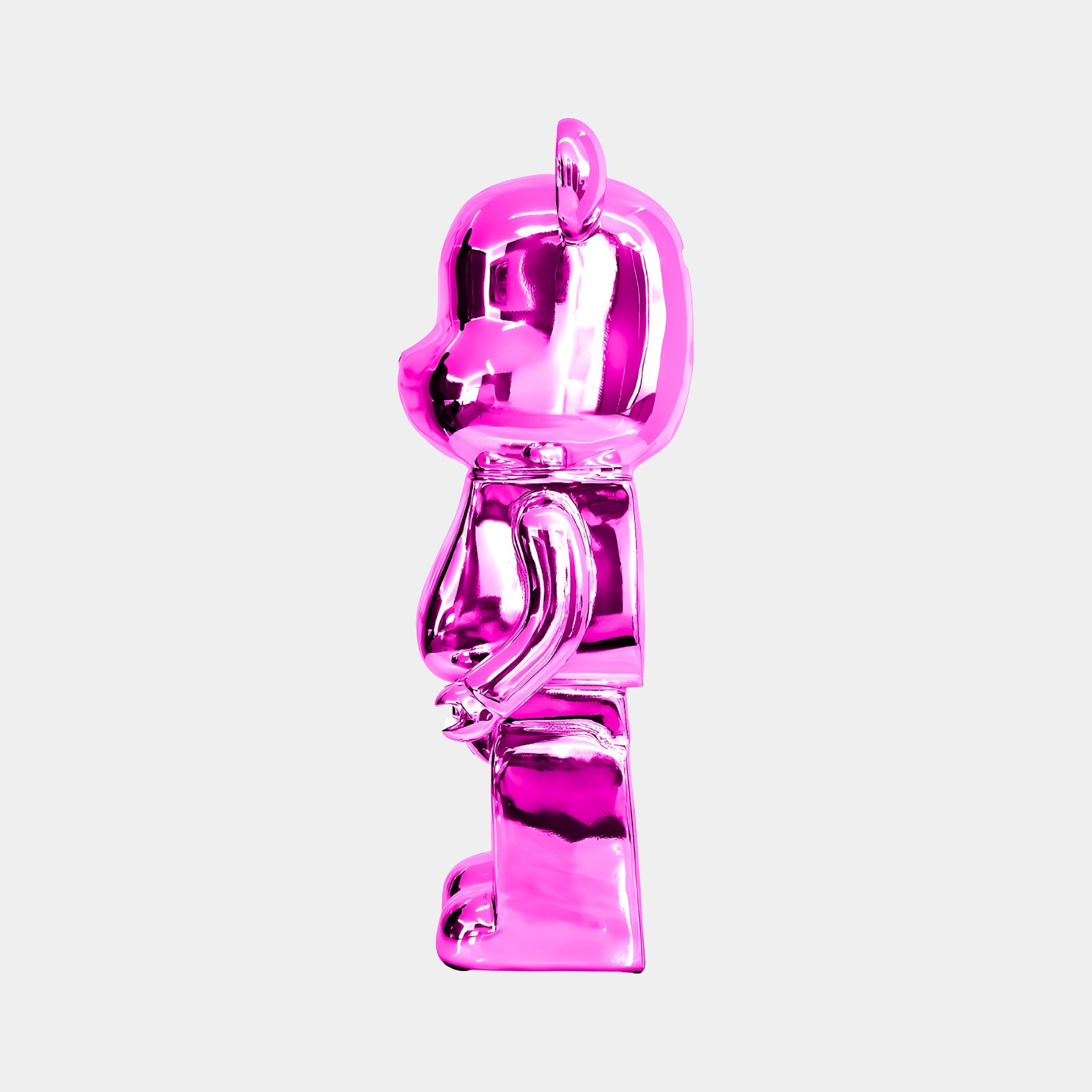 The Flamingo Pink Bear Sculpture - 50cm by Giant Sculptures stands upright, facing left, with a smooth and reflective surface featuring vibrant electroplated accents that give it a metallic appearance. Its artistic elegance is emphasized against the plain white background.