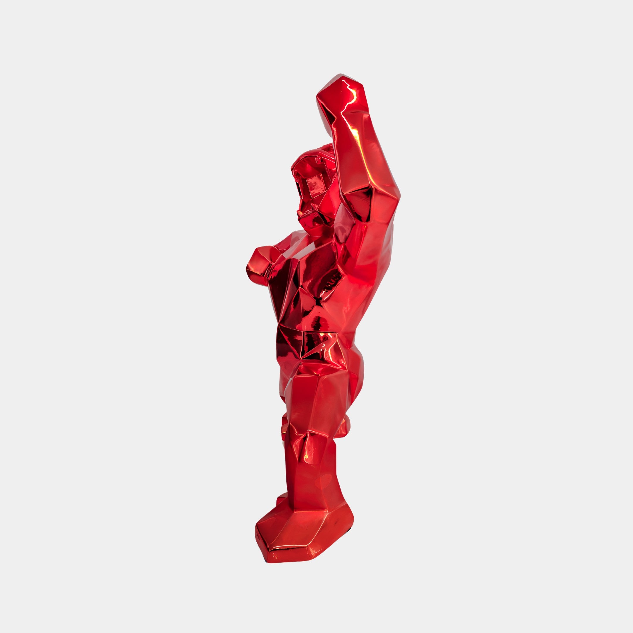 Side view of Fire Red Gorilla sculpture showcasing the detailed muscular design and striking red hue, perfect for statement interior decor.