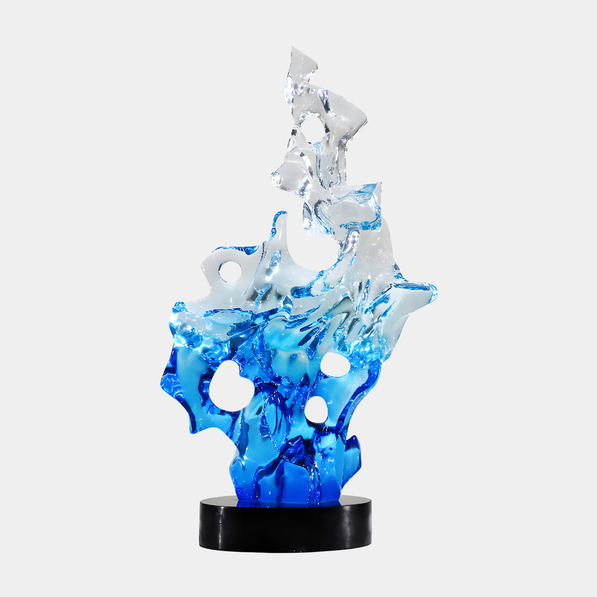 Clear Blue Graded Flame Form Resin Sculpture, 76cm, flame-shaped piece fading from clear to cobalt blue with rounded holes, on a round black marble base, plain white background.
