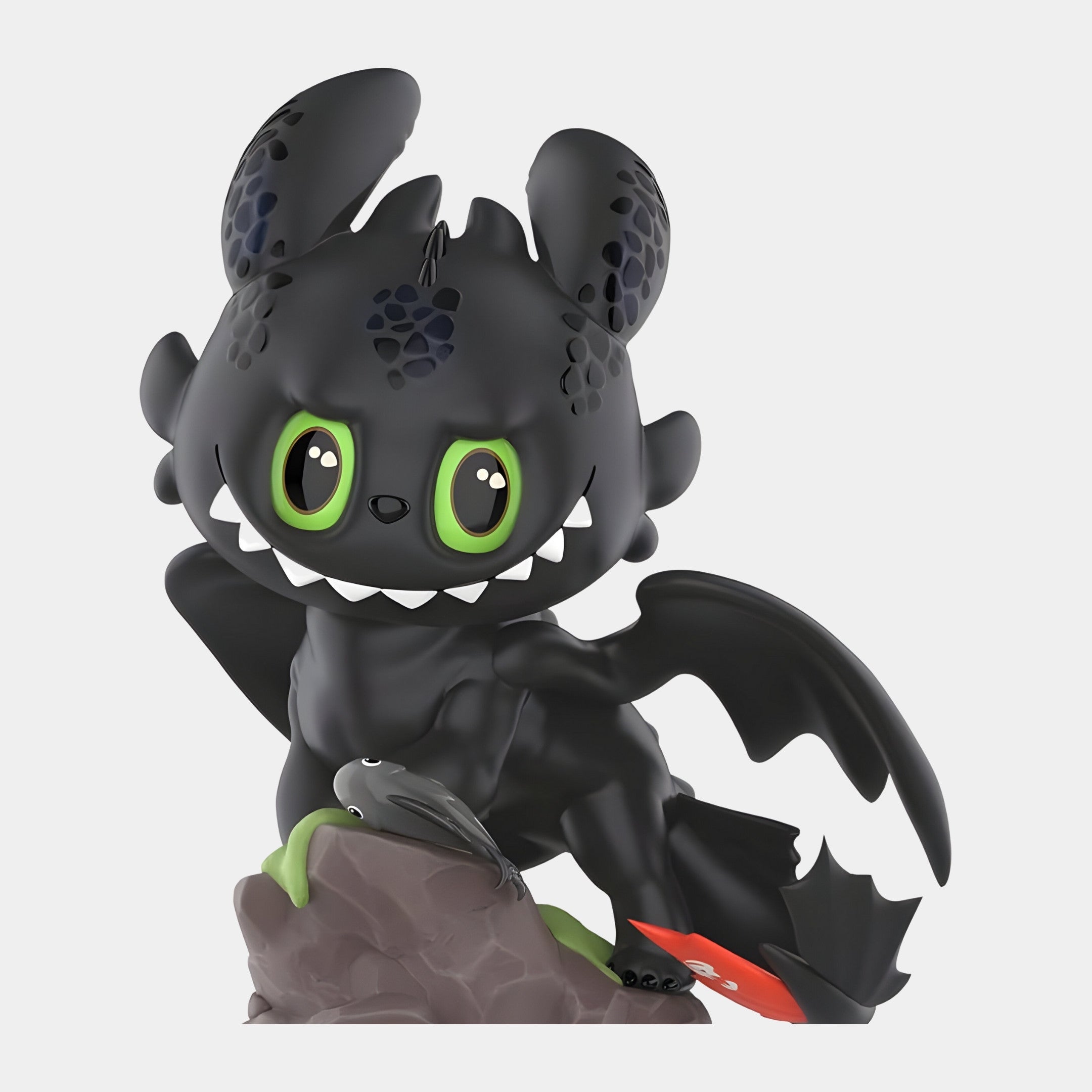 The Giant Sculptures Dragon Bond Toothless Labubu Sculpture (160cm) features a playful black dragon with big green eyes, large ears, small wings, and a red prosthetic tail fin, sitting on a rock in fantasy-inspired style.
