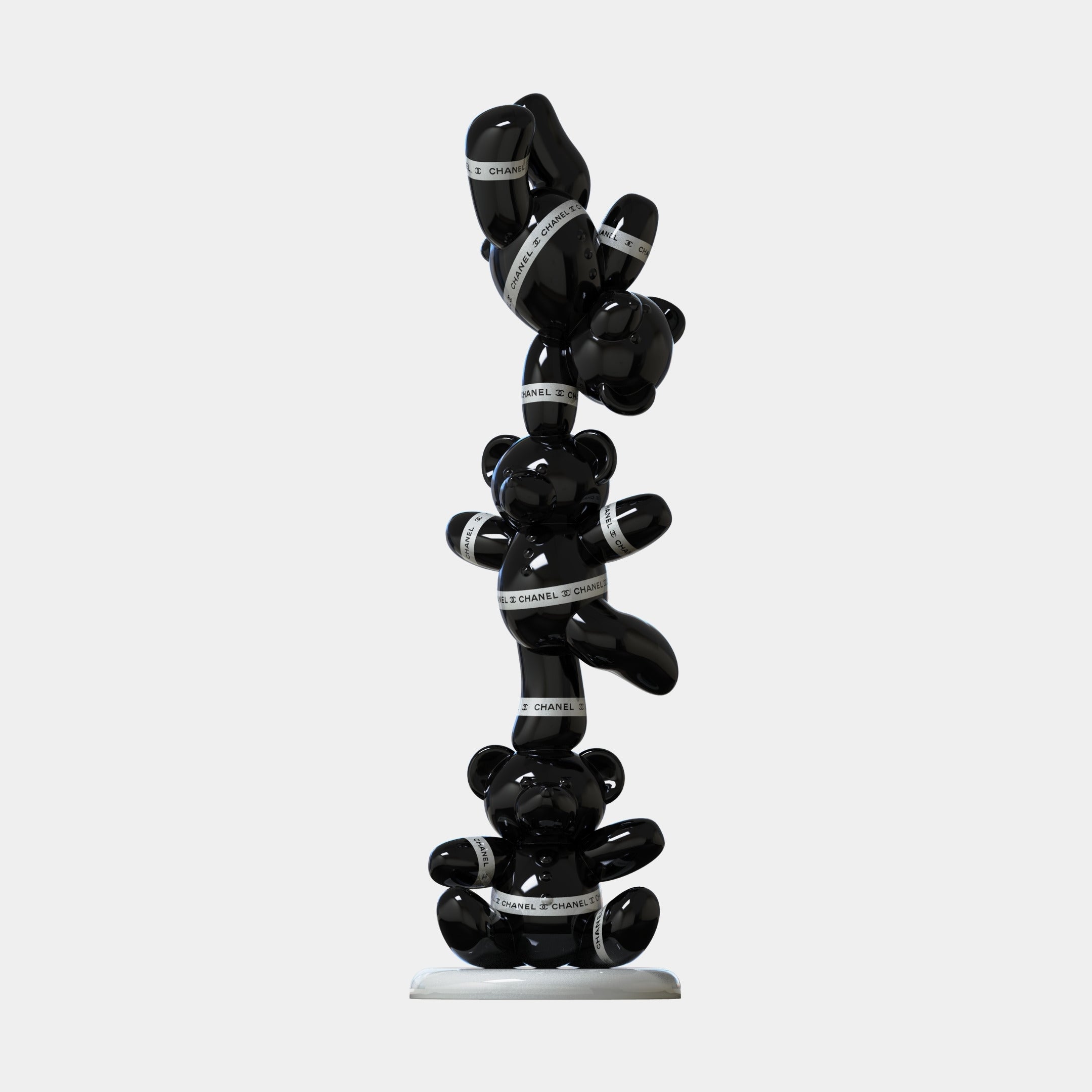 The Gacko Black Chanel Triple Bear Sculpture (90cm) by Giant Sculptures features three glossy black bears stacked with white “CHANEL” ribbon on a white base, making a bold statement in contemporary art decor.