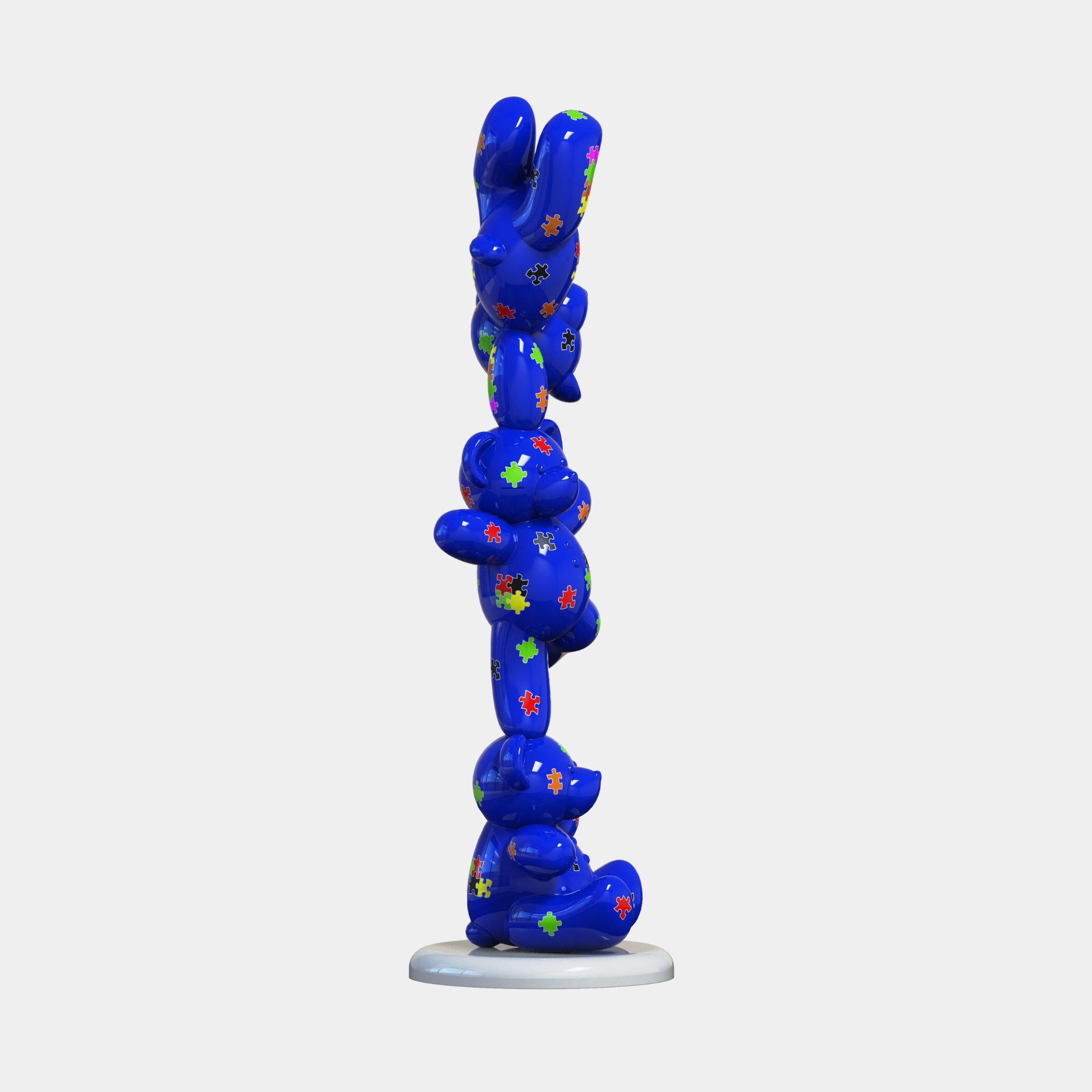 The Gacko Puzzle Triple Bear Sculpture - 90cm by Giant Sculptures features stacked, cartoon-style bears with vibrant puzzle patterns on a glossy blue finish, standing upright on a round white base—a striking contemporary piece.