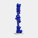 The Gacko Puzzle Triple Bear Sculpture - 90cm by Giant Sculptures features stacked, cartoon-style bears with vibrant puzzle patterns on a glossy blue finish, standing upright on a round white base—a striking contemporary piece.