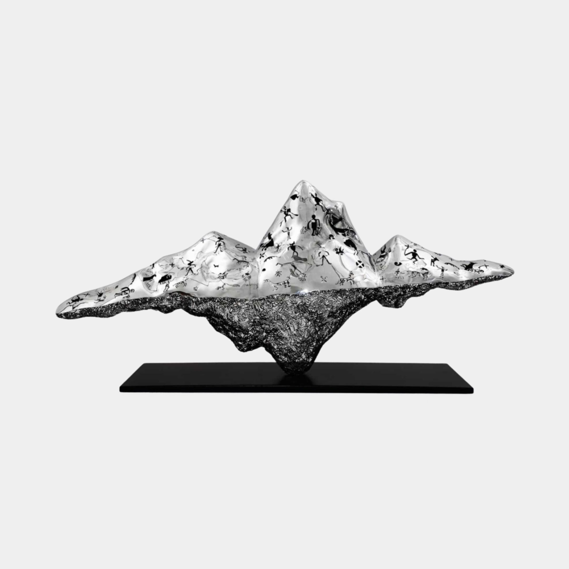 Giant Sculptures Silver Mountain Range with Cave Art metal sculpture, 165cm, mirror-polished peaks with black figures above a dark textured base on a stand.