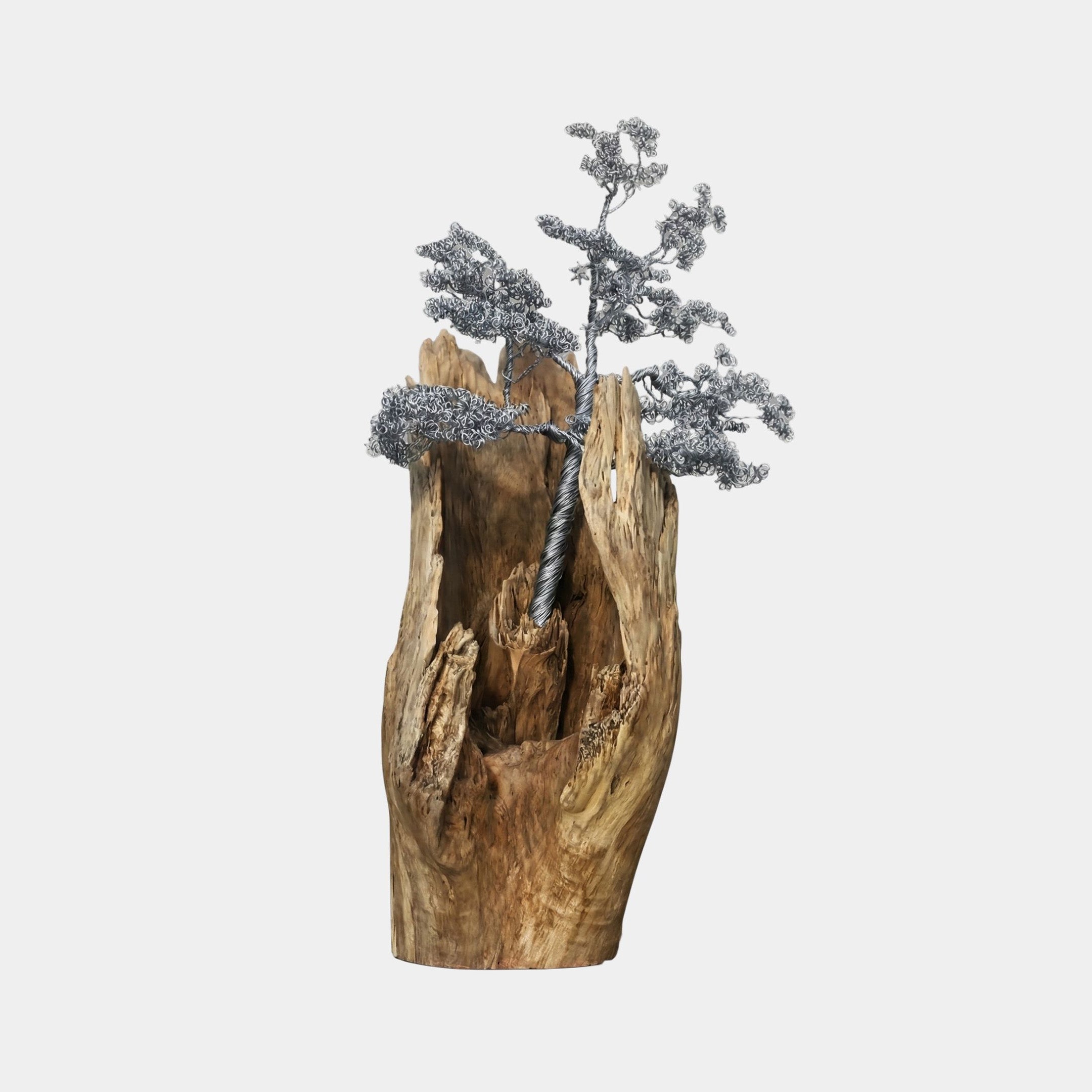 Silver Metallic Wire-Twist Tree Driftwood Base Sculpture 140cm by Giant Sculptures, with wire foliage rising from a weathered split log on a light background.
