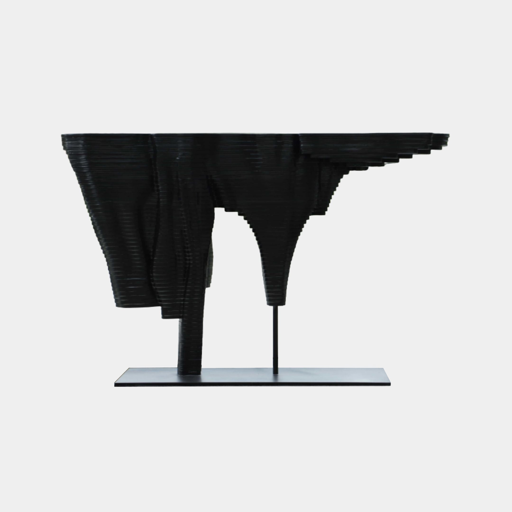 Giant Sculptures Black Layered Topographic Silhouette Metal Sculpture 110cm, side view of stacked slices forming cliffs and funnel voids on a flat base.