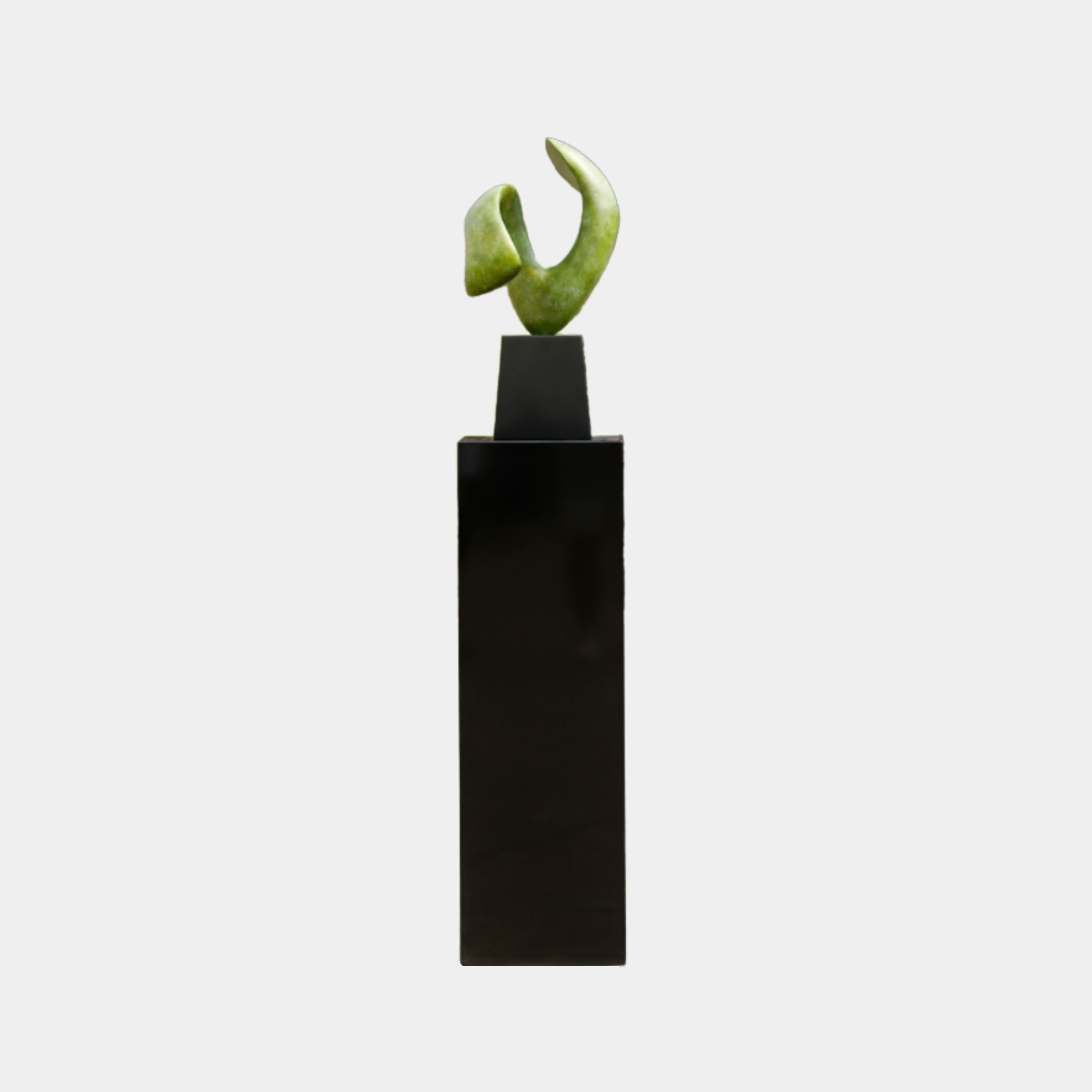Moss Green Organic Swirl Abstract Pedestal Sculpture by Giant Sculptures, two curved petal forms in a V-composition on a tall black plinth against a plain background.