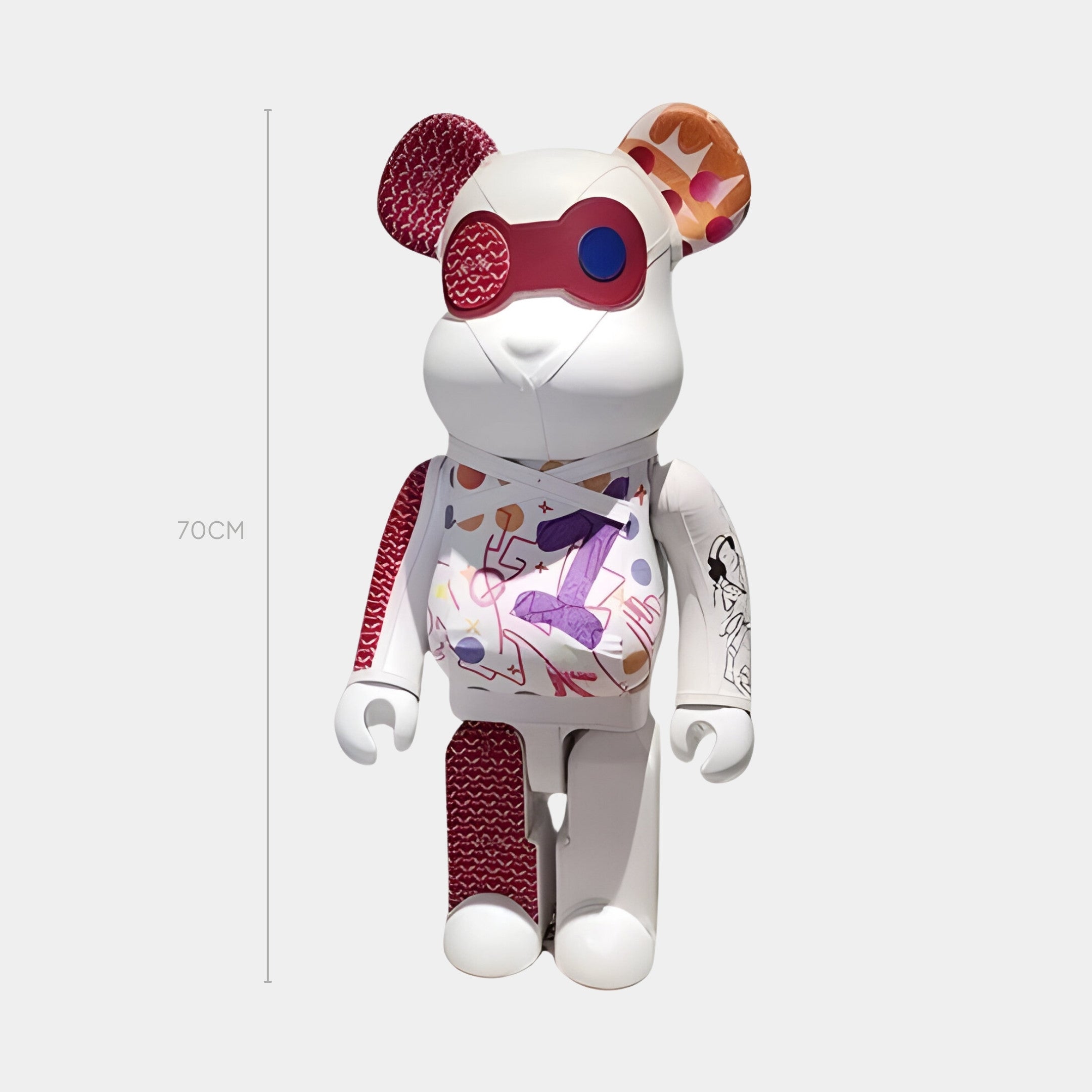 The Urban Stitch Bear Sculpture - 70cm by Giant Sculptures features street-art appliqués, one red and one patterned ear, a red eye patch, and vibrant geometric-meets-illustrated artwork on a bear-shaped designer toy.