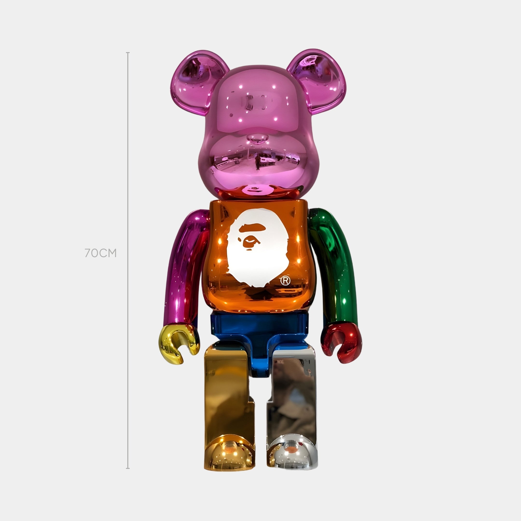 The Giant Sculptures Vibrant Color Pop Bear Sculpture - 70cm is a limited edition chrome bear in pink, orange, green, blue, red, and gold with a white ape face logo on its chest and an upright, dazzling finish.