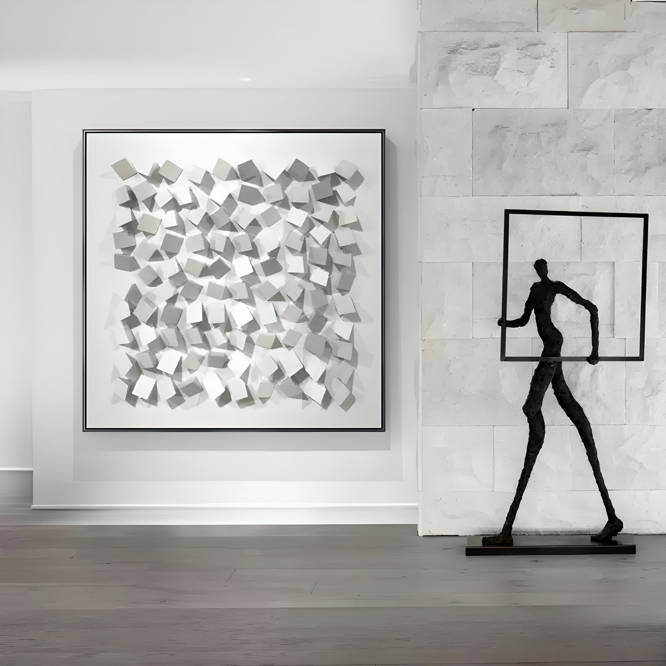 A modern art gallery space showcases the Cubitara White Abstract Wood Cluster 3D Wall Art by Giant Sculptures, featuring numerous white cubes. To the right stands a tall abstract metal figure with an empty square frame on the wooden floor, embodying white abstract wall art.