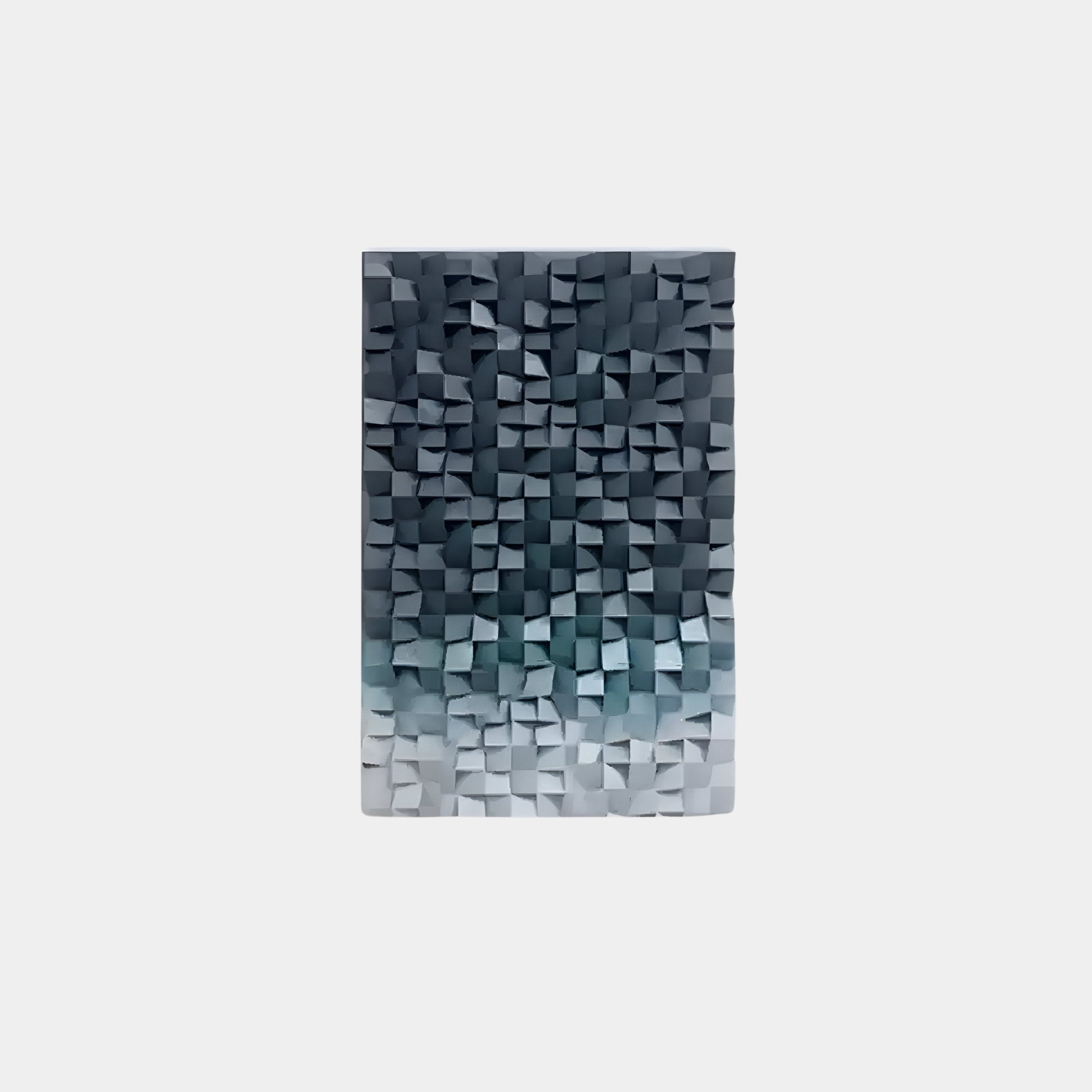 The Stratiform Monochrome Mist Gradient Wood Mosaic 3D Wall Art by Giant Sculptures features a textured, raised design of dark blue and gray squares on a light background, creating a gradient mosaic effect transitioning from dark to light shades.