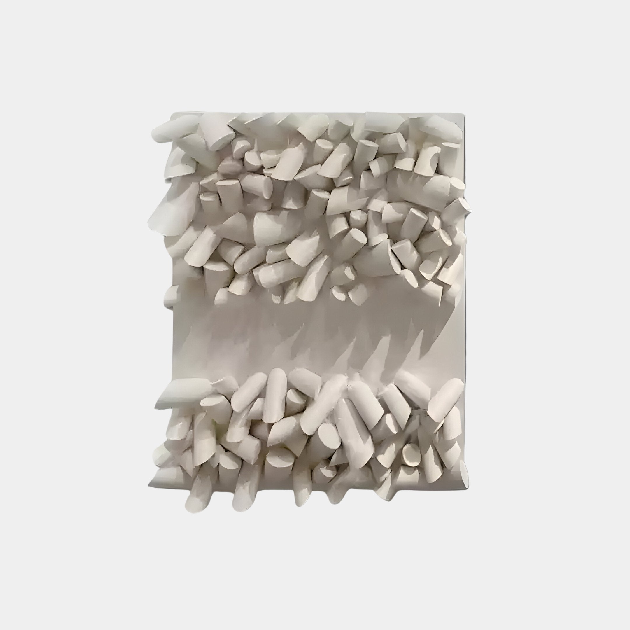 The Forme IV Cream Wood Cluster Abstract 3D Wall Art by Giant Sculptures showcases irregularly shaped white fragments on a flat background, creating a textured, three-dimensional design that enhances modern interiors with its unique and organic artistry.