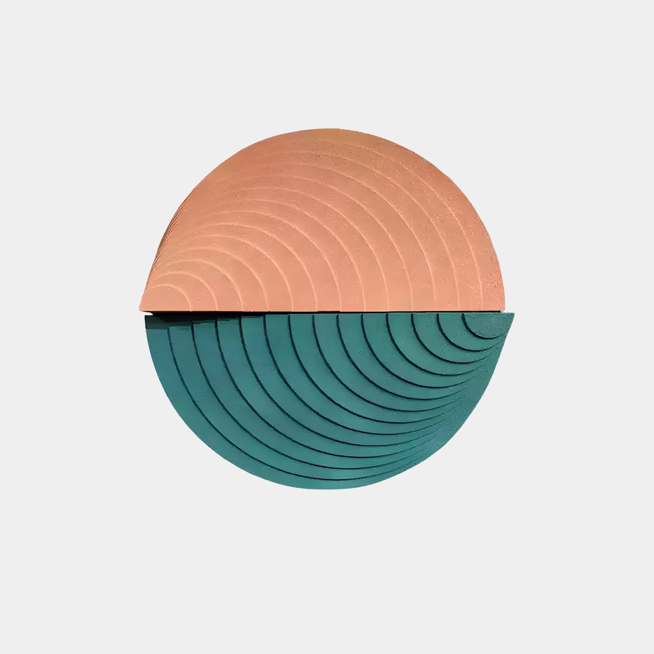 The Orbitals Peach & Teal Circular Wood Carved Sandstone 3D Wall Art by Giant Sculptures showcases dynamic halves: the top in peach with concentric curves and the bottom in teal with matching patterns, creating a minimalistic geometric design against a plain background.