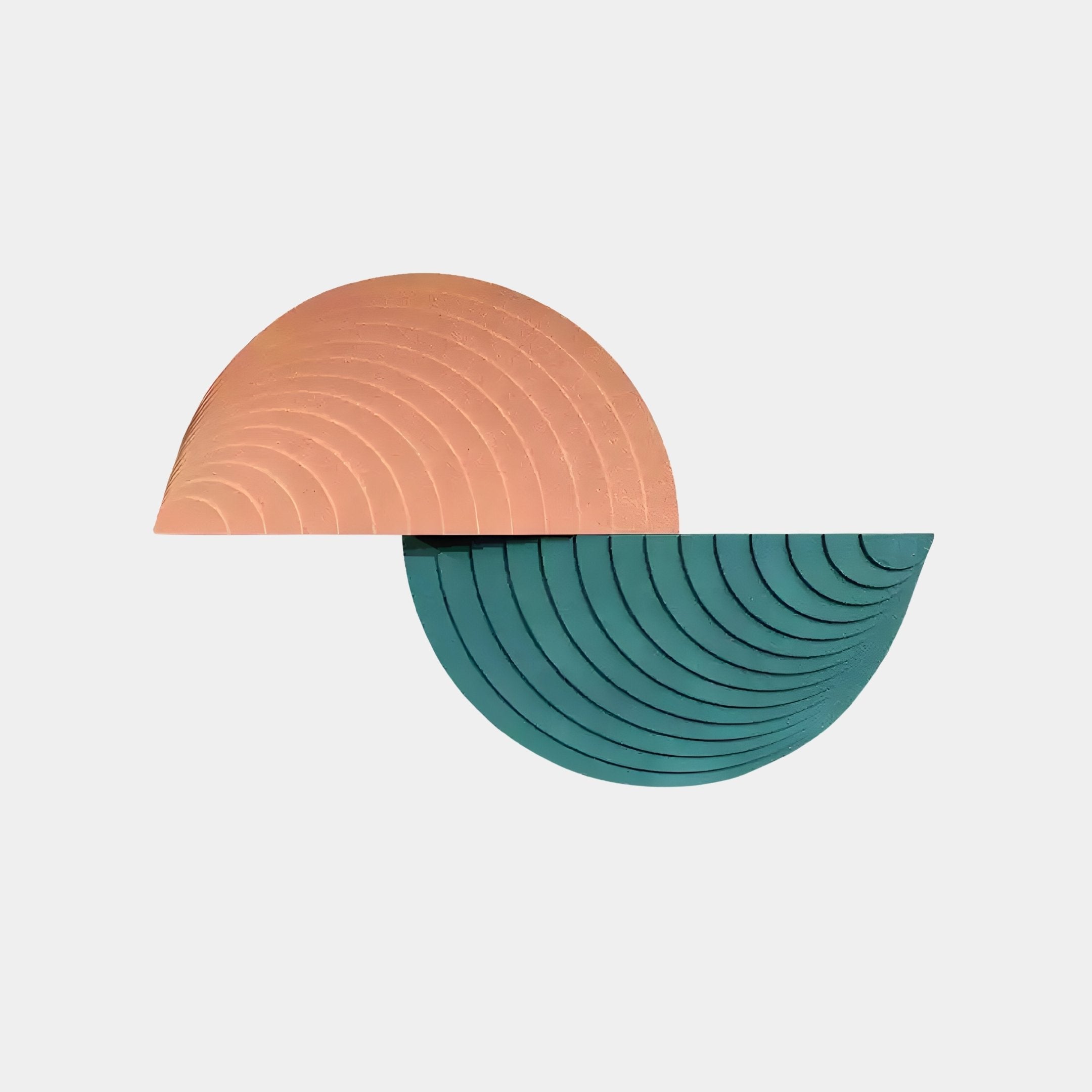 Giant Sculptures Orbitals Peach & Teal Semi-Circle Wall Art showcases abstract interlocking semi-circles. The orange and teal shapes, carved in sandstone with concentric grooves, form an elegant pattern on a white background, ideal for contemporary interiors.