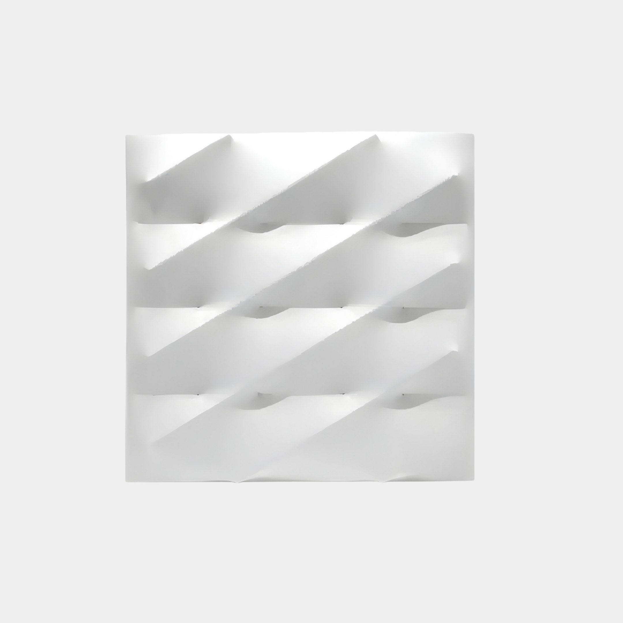 The Giant Sculptures Verto White Stretch Fabric Layered Wooden 3D Wall Art epitomizes modern wall art with its minimalist design, featuring a grid of diagonal ridges that create triangular shadows against a plain background.