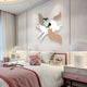 In a cozy bedroom, the Mythoria Journey Fairytale Horse Wooden LED Wall Art by Giant Sculptures adorns the wall, depicting a person on a winged horse. The bed sports a pink and white theme with a knot pillow and violin, while soft lighting and pastels enhance the serene childrens decor.