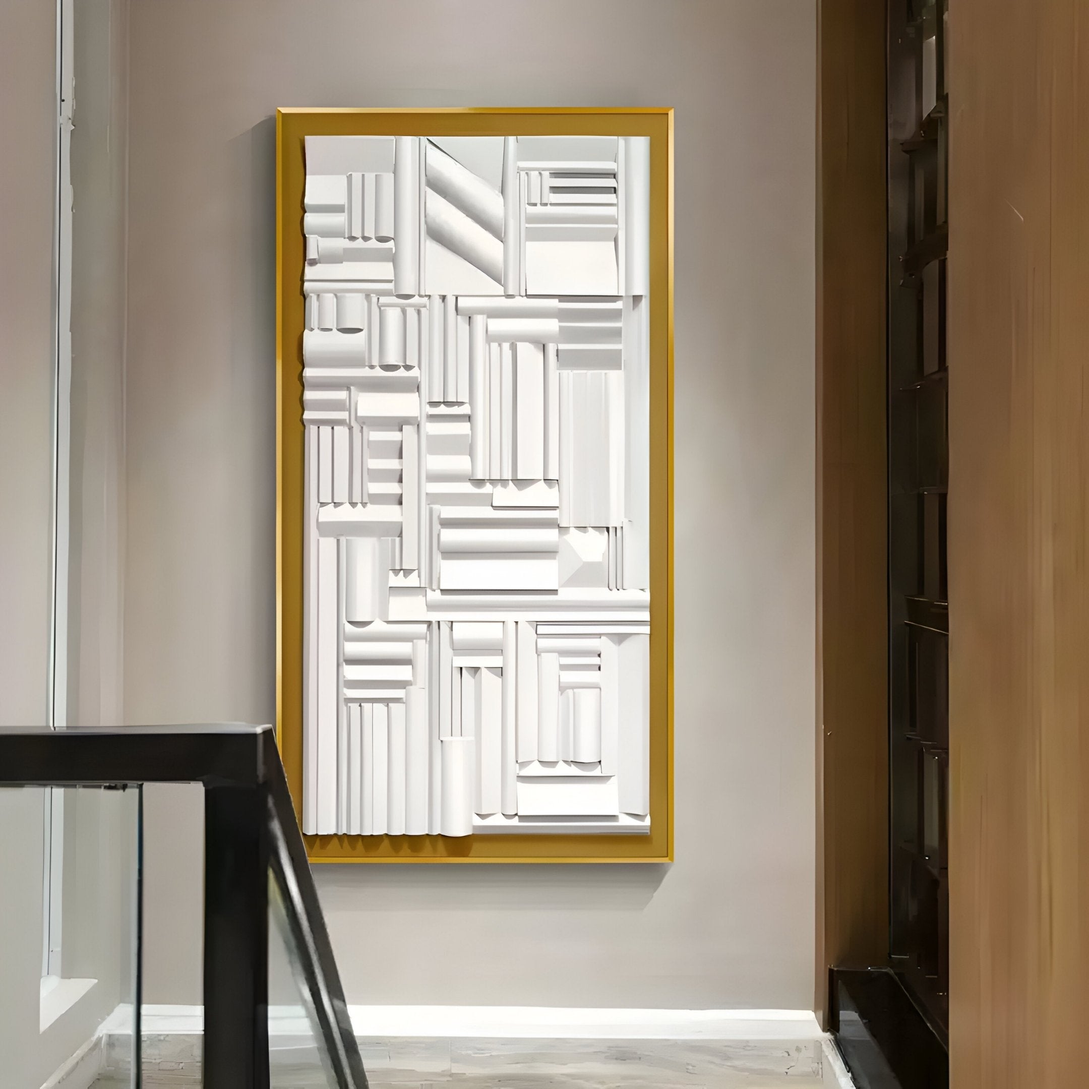 The Forma Gold-Frame White Geometric 3D Wooden Vertical Wall Art by Giant Sculptures features a 3D white pattern in a gold frame, perfect for modern interiors. Its craftsmanship shines against neutral decor, with sleek glass railing adding to the elegance in the foreground.