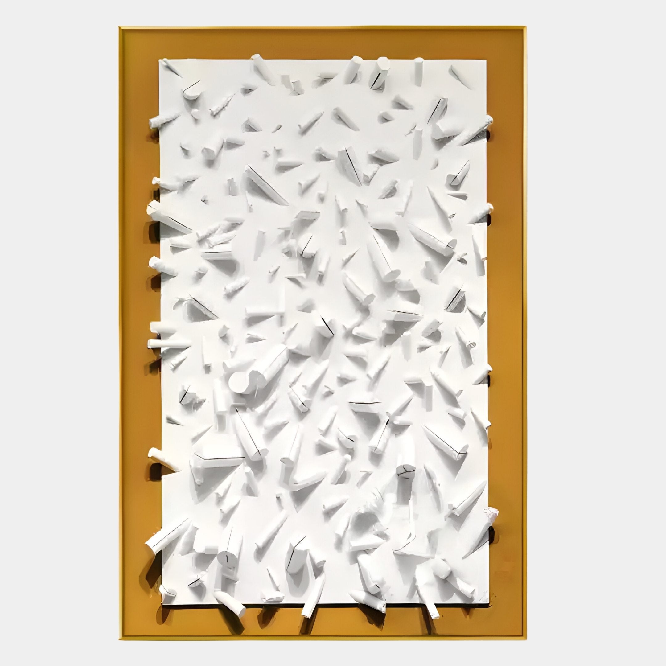 The Artiora Gold Edge & White Abstract Wooden Shard 3D Wall Art by Giant Sculptures features scattered white geometric shapes on a flat white surface, set in a gold-edged mustard yellow frame with a light gray background.