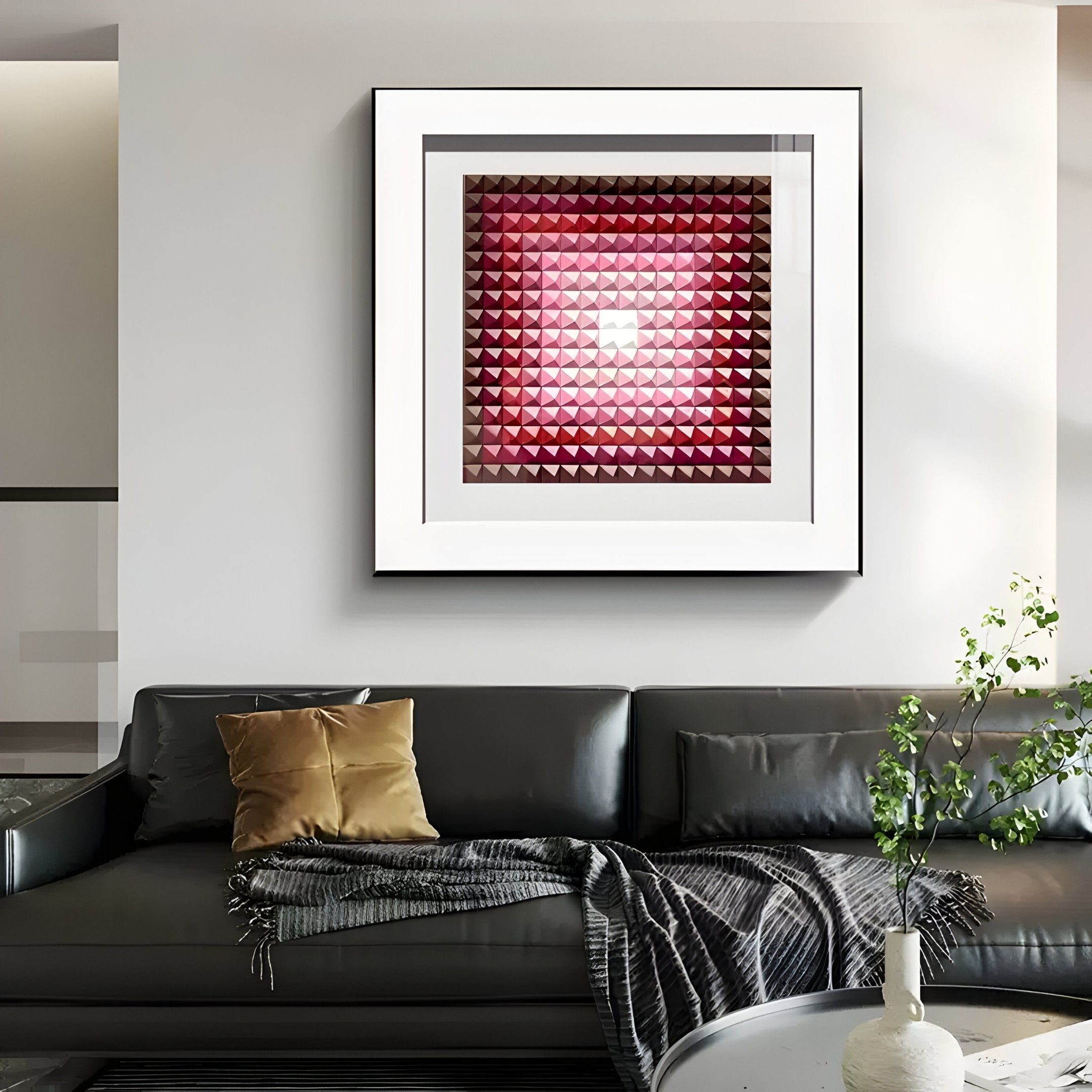 A modern living room showcases a dark gray sofa with a brown cushion and gray throw. Above the sofa, the Giant Sculptures Viretta Red Gradient Pyramid Textured 3D Wooden Wall Art creates a striking focal point. A small plant enhances the decor on the white coffee table.