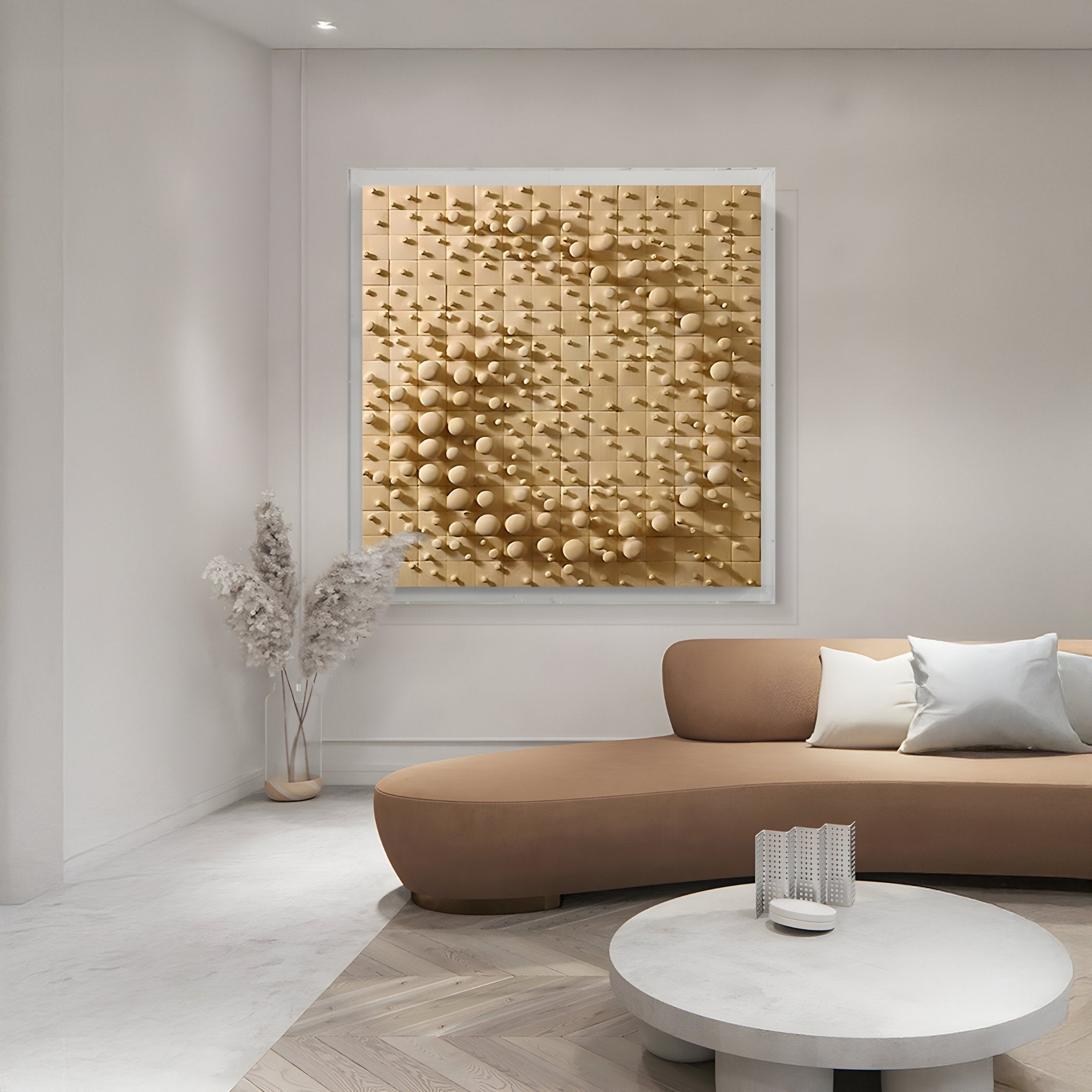 A modern living room features a beige curved sofa with white and gray cushions, promoting circular flow. The wall presents the Orbila Circular Flow Wooden Spheres 3D Wall Art by Giant Sculptures. In the corner, a vase of dried plants enhances this modern interior decor.