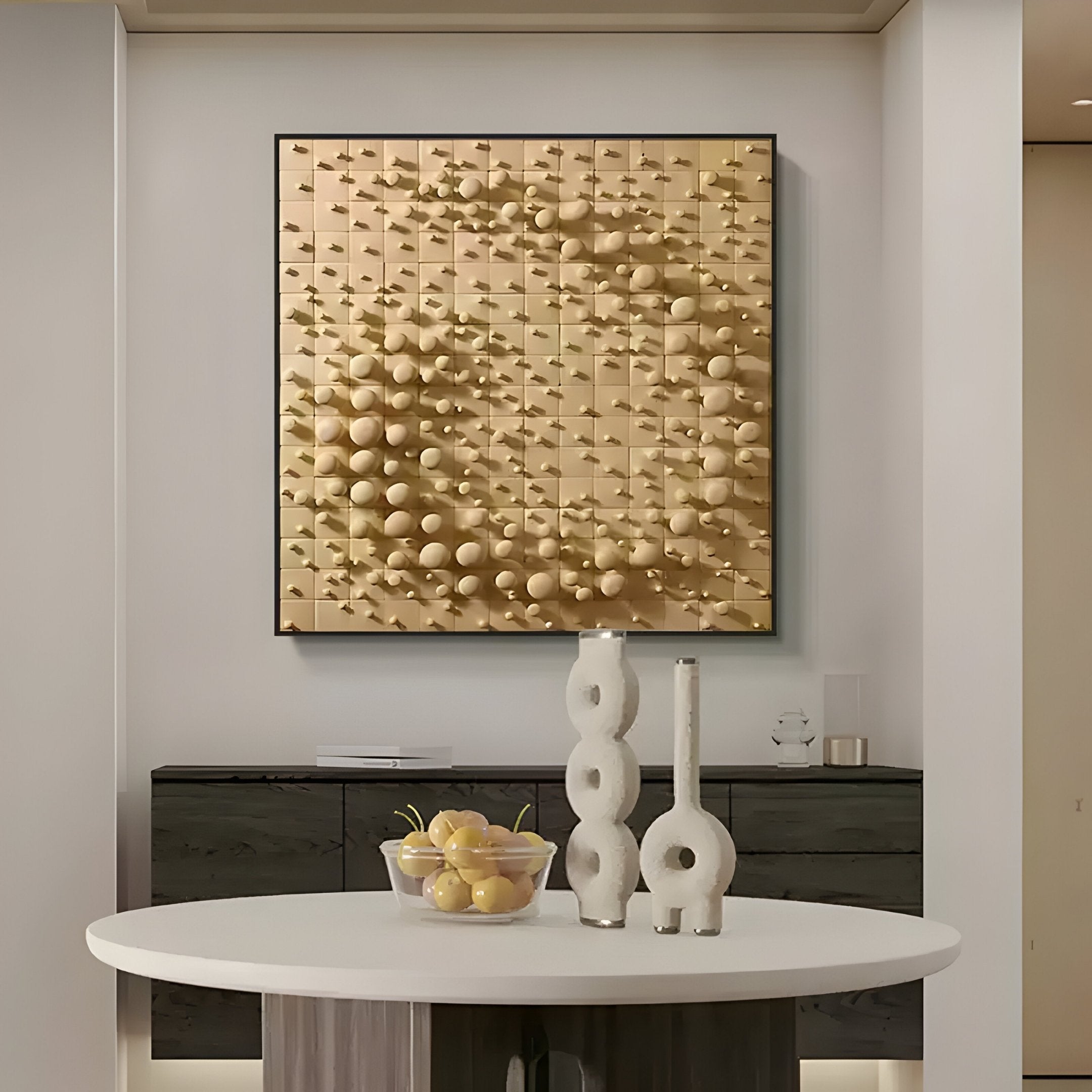 A modern interior includes a round white table with two white vases and a bowl of lemons, set against Giant Sculptures Orbila Circular Flow Wooden Spheres 3D Wall Art. The yellow spheres and rods create a striking geometric pattern above a black cabinet.