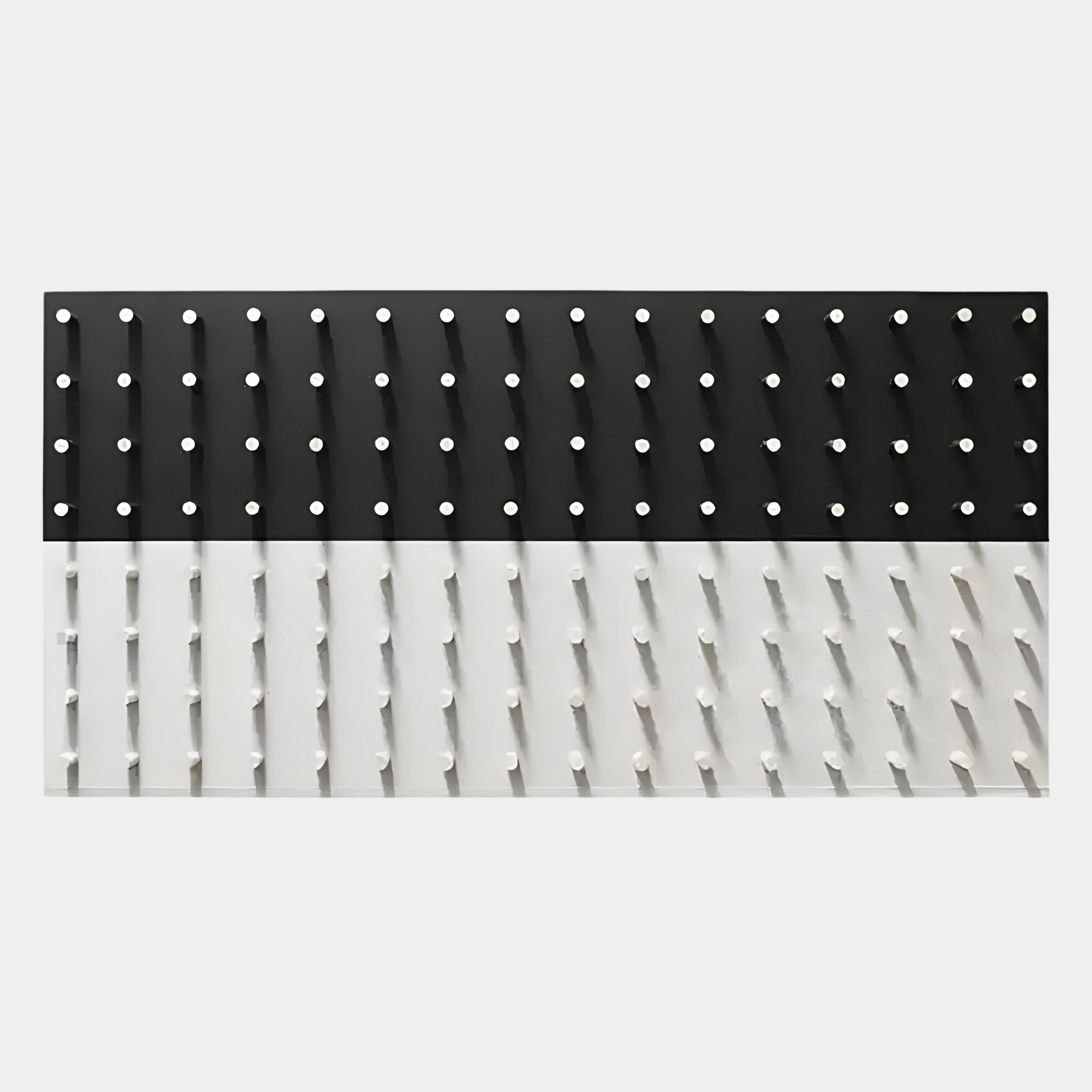 The Contrasto Black & White Linear 3D Wooden Wall Art by Giant Sculptures features a rectangular design with black and white halves, each section lined with pegs casting geometric shadows for a bold monochrome installation.