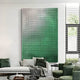 In a modern living room, a white sofa with green pillows and a green blanket takes center stage. A Reflexion Green Gradient Cube Mosaic 3D Wooden Wall Art by Giant Sculptures adds geometric precision above. Natural light floods in through a large window with blinds, accentuating the chic decor.