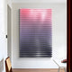 The Wavluxe Gradient Pink & Purple Wood Mosaic Vertical 3D Wall Art from Giant Sculptures is a stunning piece featuring small rectangles shifting from pink to blue. Mounted on a white wall in a modern room, it complements the wooden chair and white table with its sleek design.